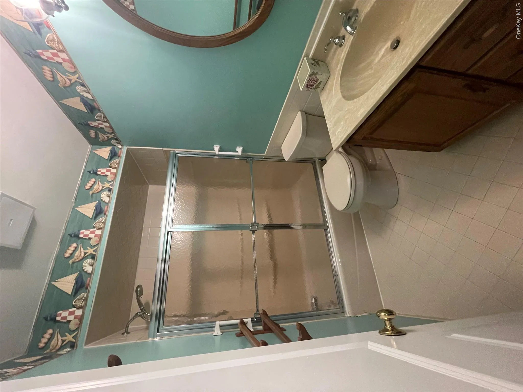 Full bathroom featuring toilet, tile patterned flooring, bath / shower combo with glass door, and vanity Full bathroom featuring toilet, tile patterned flooring, bath / shower combo with glass door, and vanity