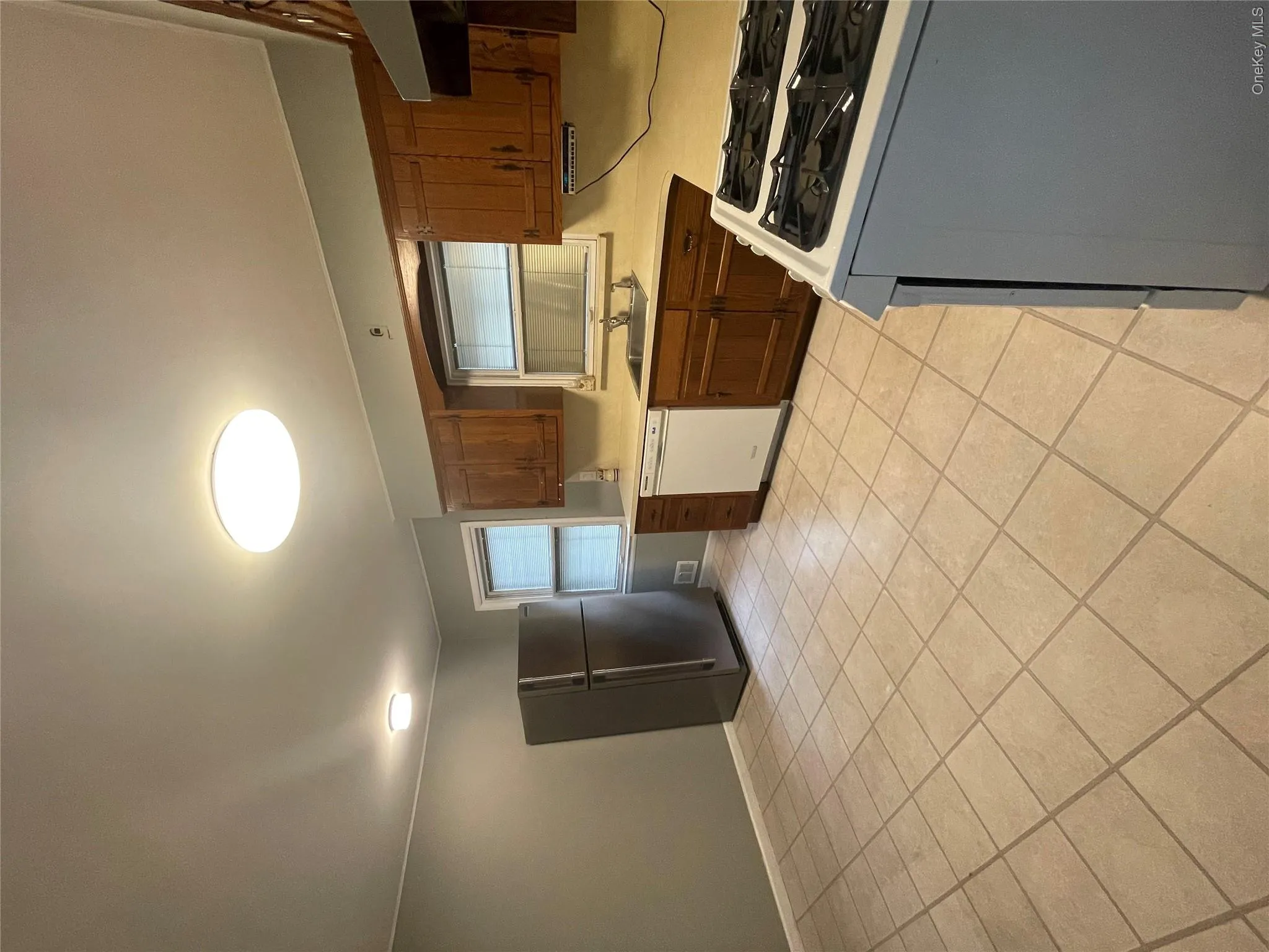 Kitchen featuring refrigerator, a sink, light countertops, range, and dishwasher Kitchen featuring refrigerator, a sink, light countertops, range, and dishwasher
