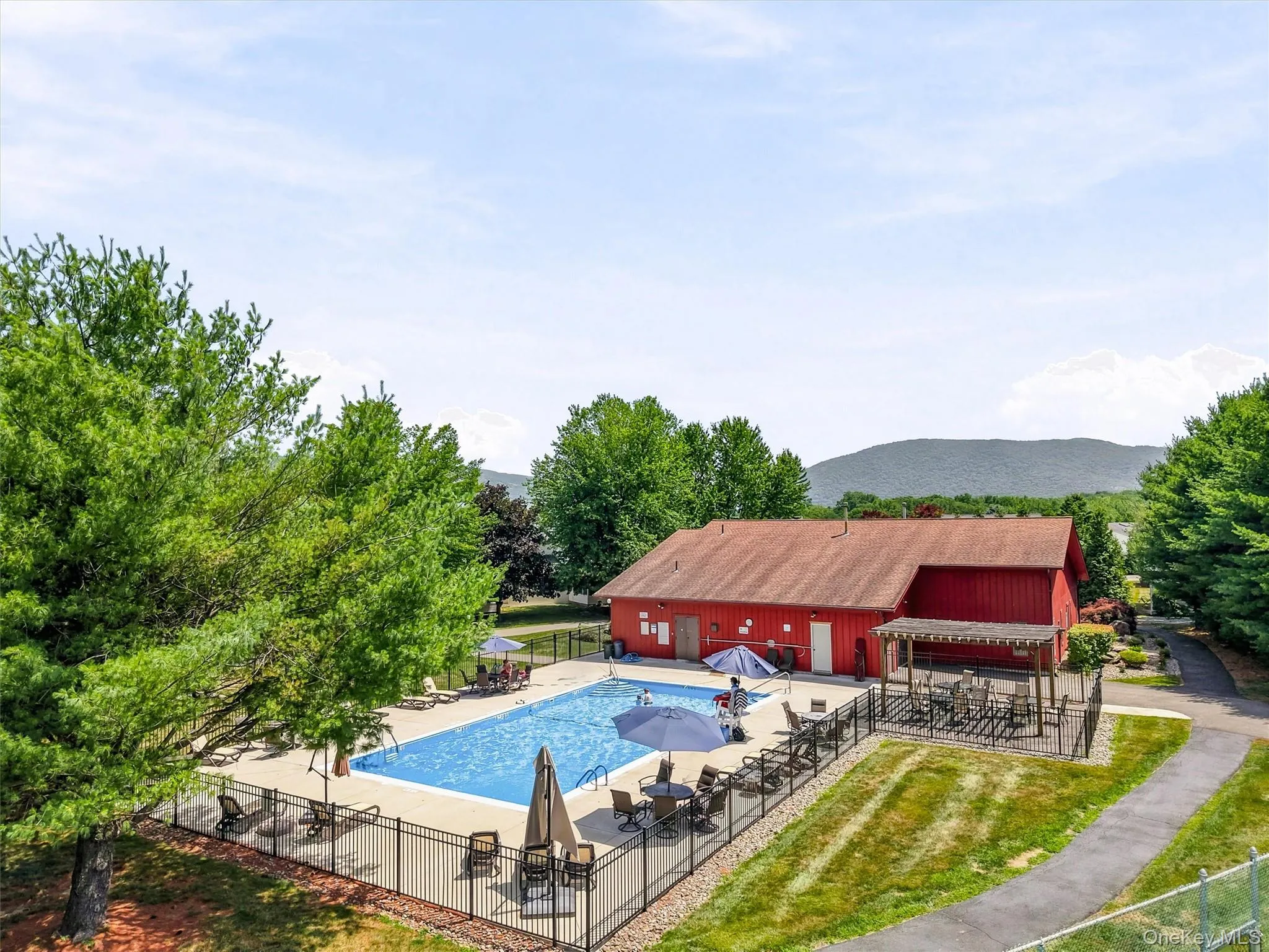 Community pool and clubhouse offering residents spacious lounge areas and scenic mountain views Community pool and clubhouse offering residents spacious lounge areas and scenic mountain views