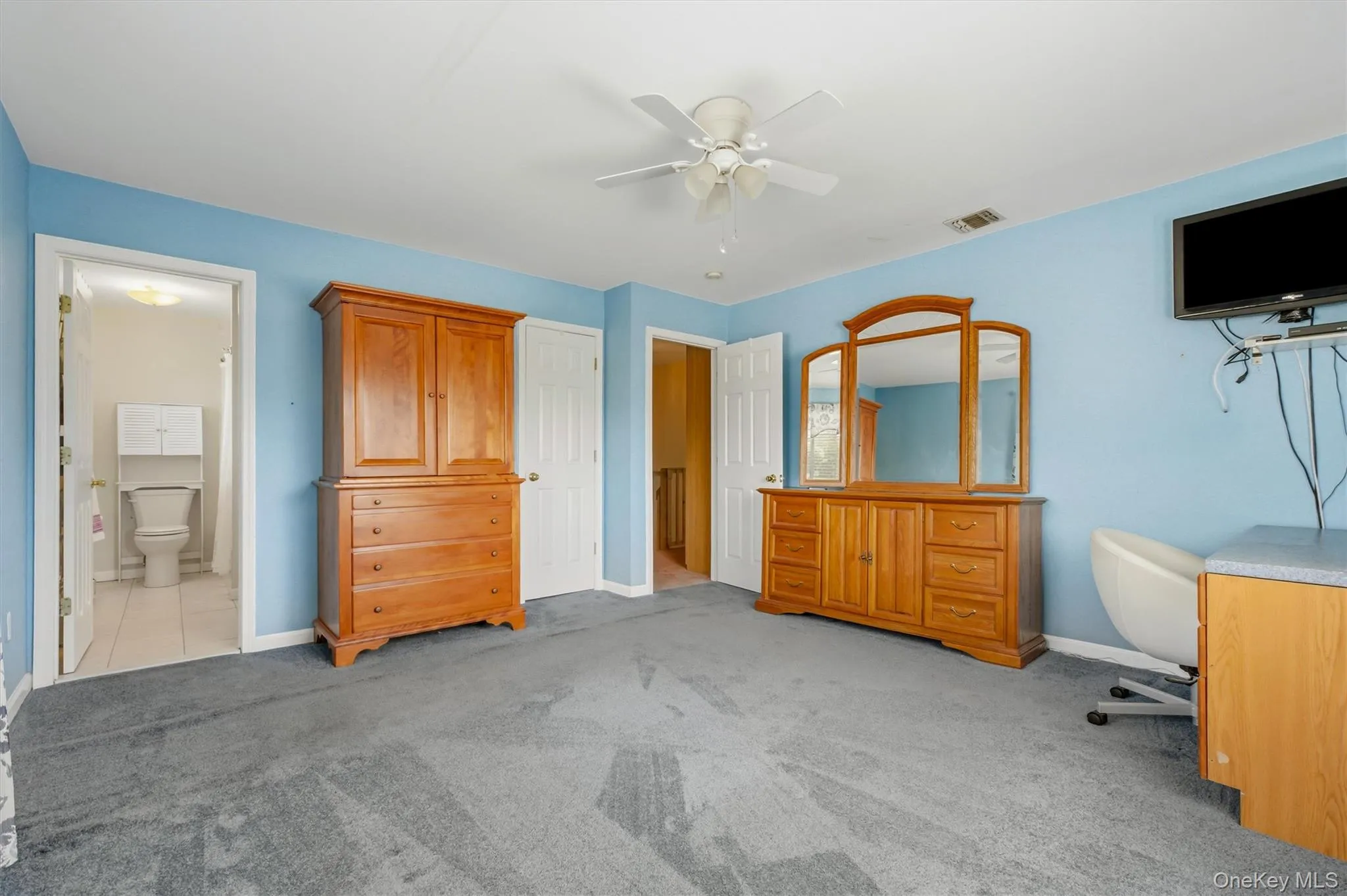 Spacious primary bedroom featuring an en-suite bath, generous closet space Spacious primary bedroom featuring an en-suite bath, generous closet space