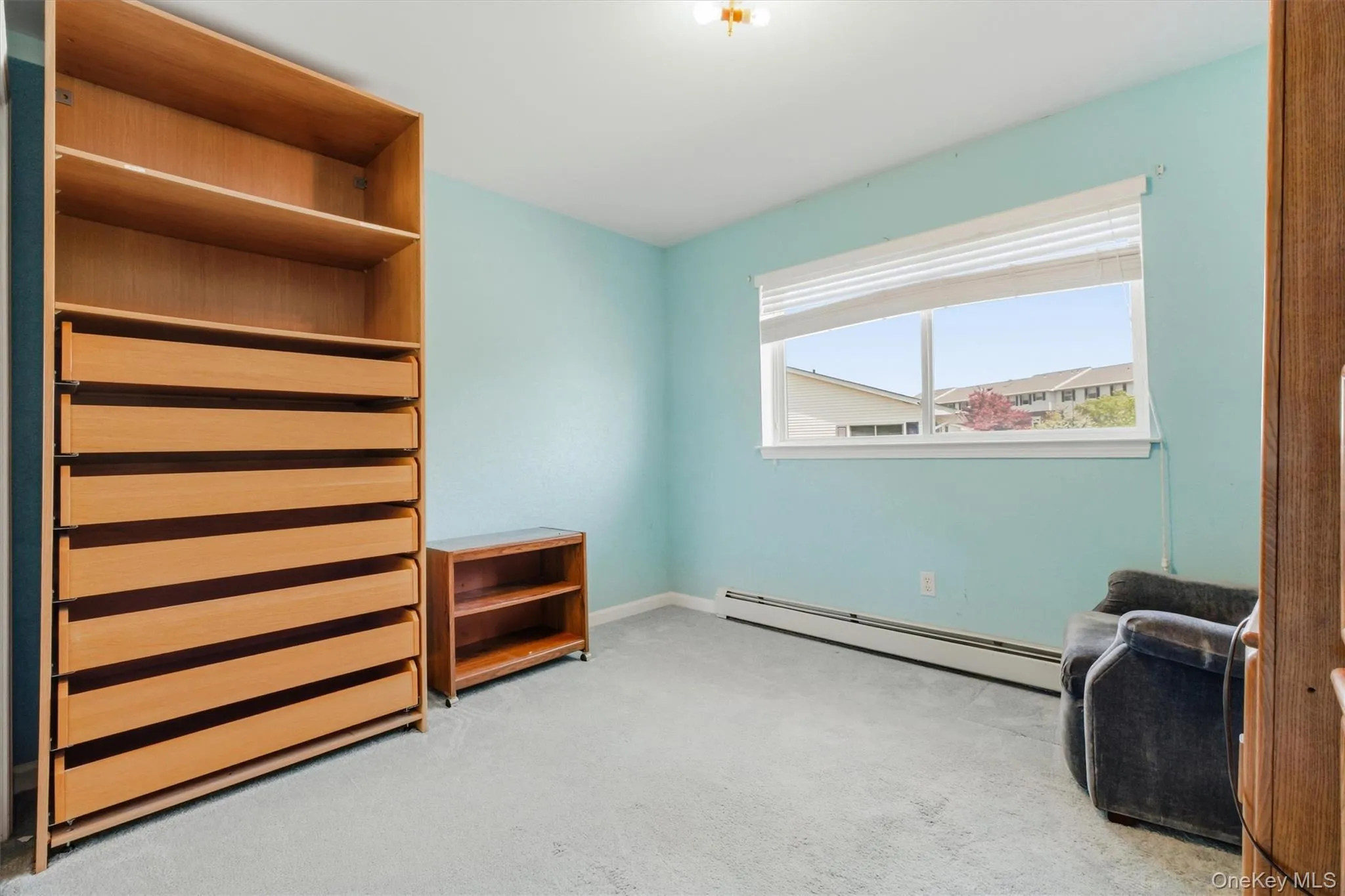 Bright bedroom featuring a large window, ample closet space, and flexible use Bright bedroom featuring a large window, ample closet space, and flexible use