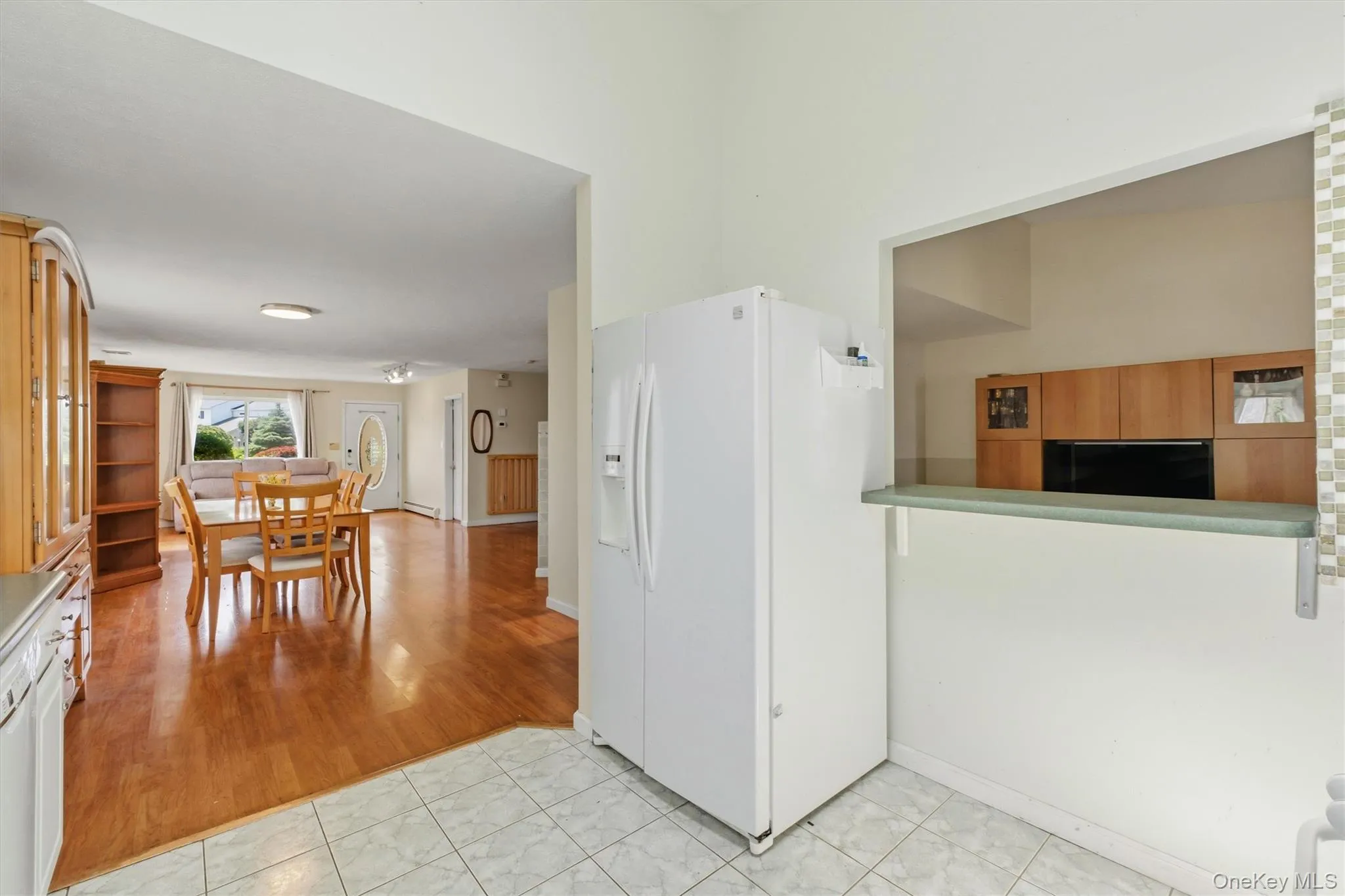 Kitchen pass-through window with a tiled accent wall and light countertop Kitchen pass-through window with a tiled accent wall and light countertop