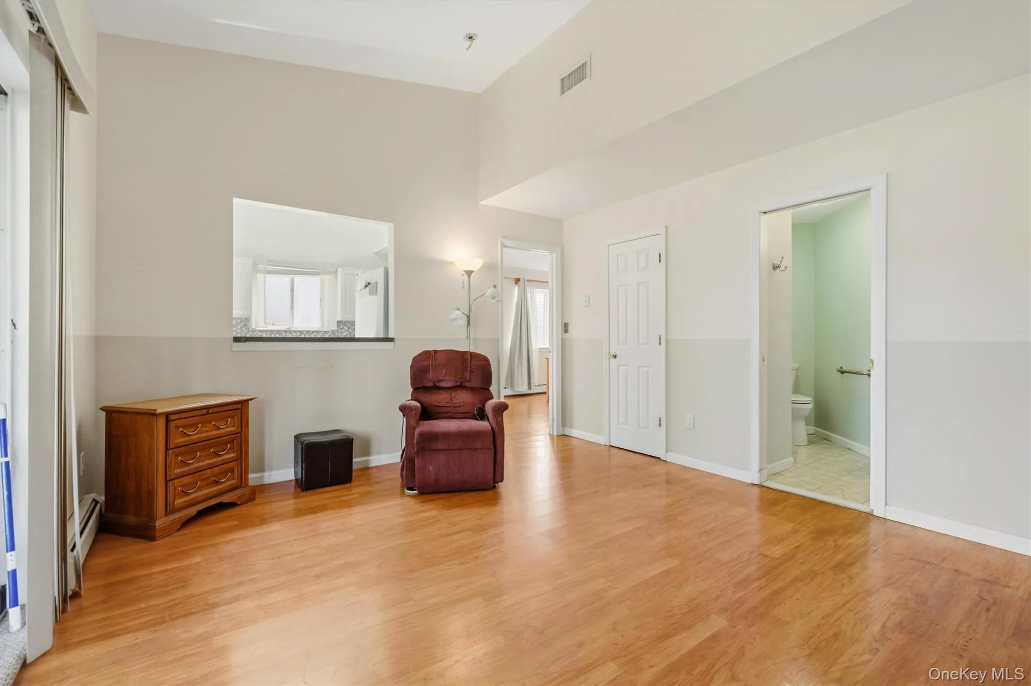 Spacious interior featuring wood-finish flooring and a vaulted ceiling Spacious interior featuring wood-finish flooring and a vaulted ceiling