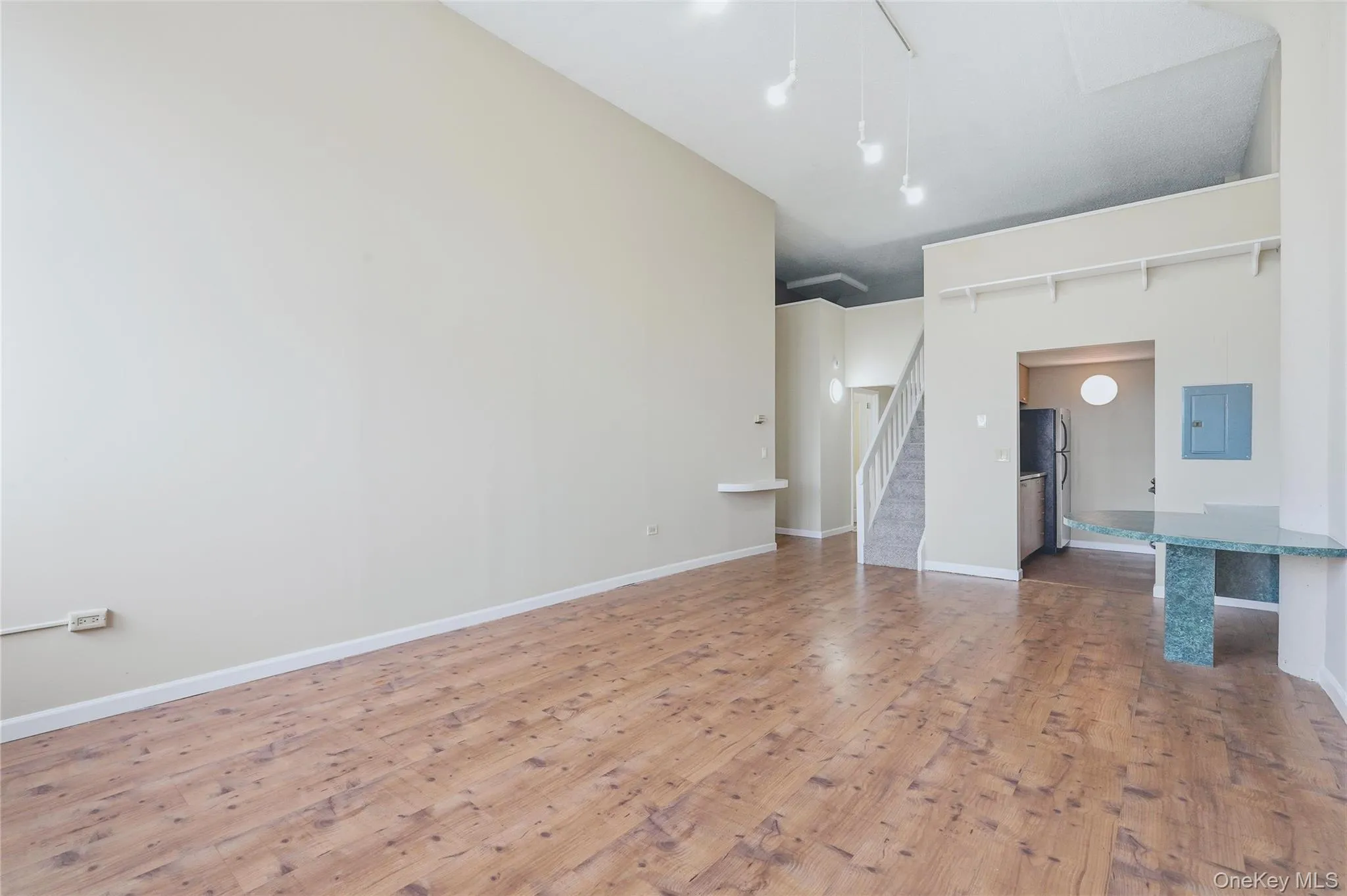 View towards entry foyer, stairs to office and sleeping alcove. and kitchen View towards entry foyer, stairs to office and sleeping alcove. and kitchen