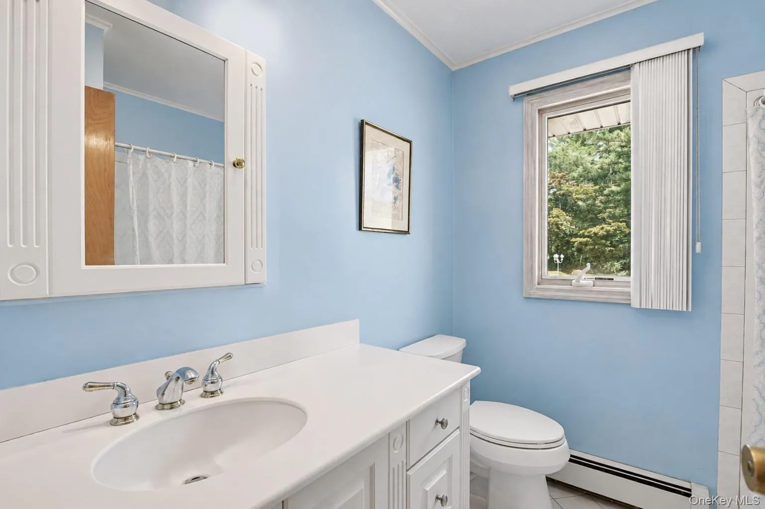 Bathroom featuring a white vanity with an undermount sink, chrome faucet, and a wall-mounted mirrored medicine cabinet Bathroom featuring a white vanity with an undermount sink, chrome faucet, and a wall-mounted mirrored medicine cabinet