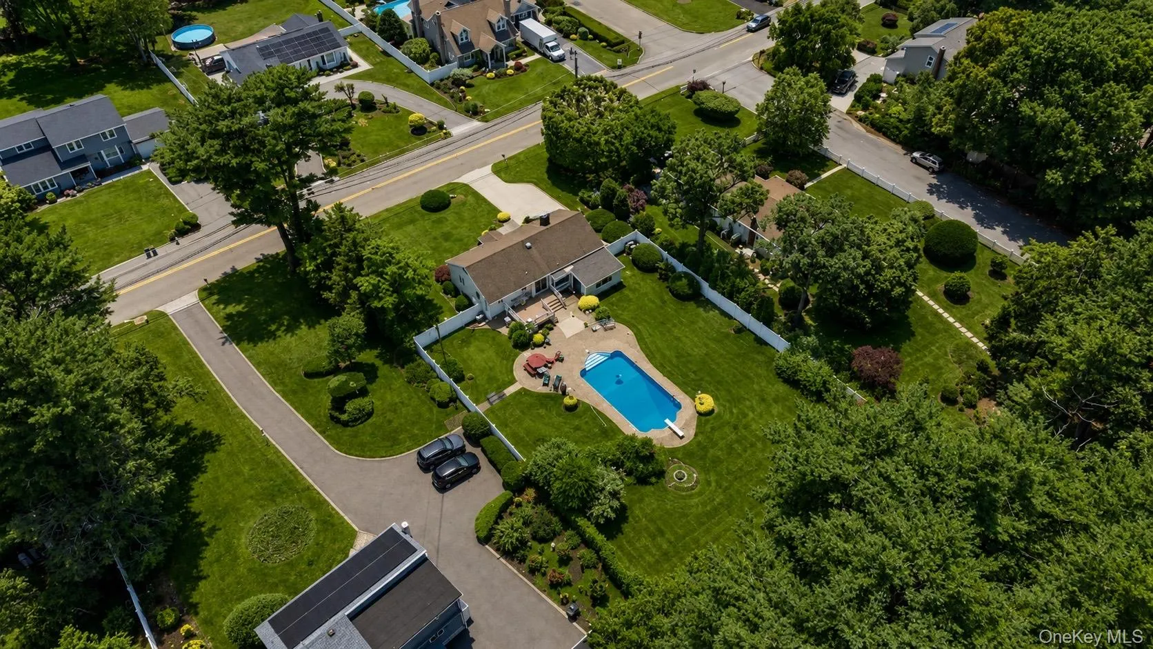 Expansive property featuring a private swimming pool, surrounding patio, and manicured lawns Expansive property featuring a private swimming pool, surrounding patio, and manicured lawns