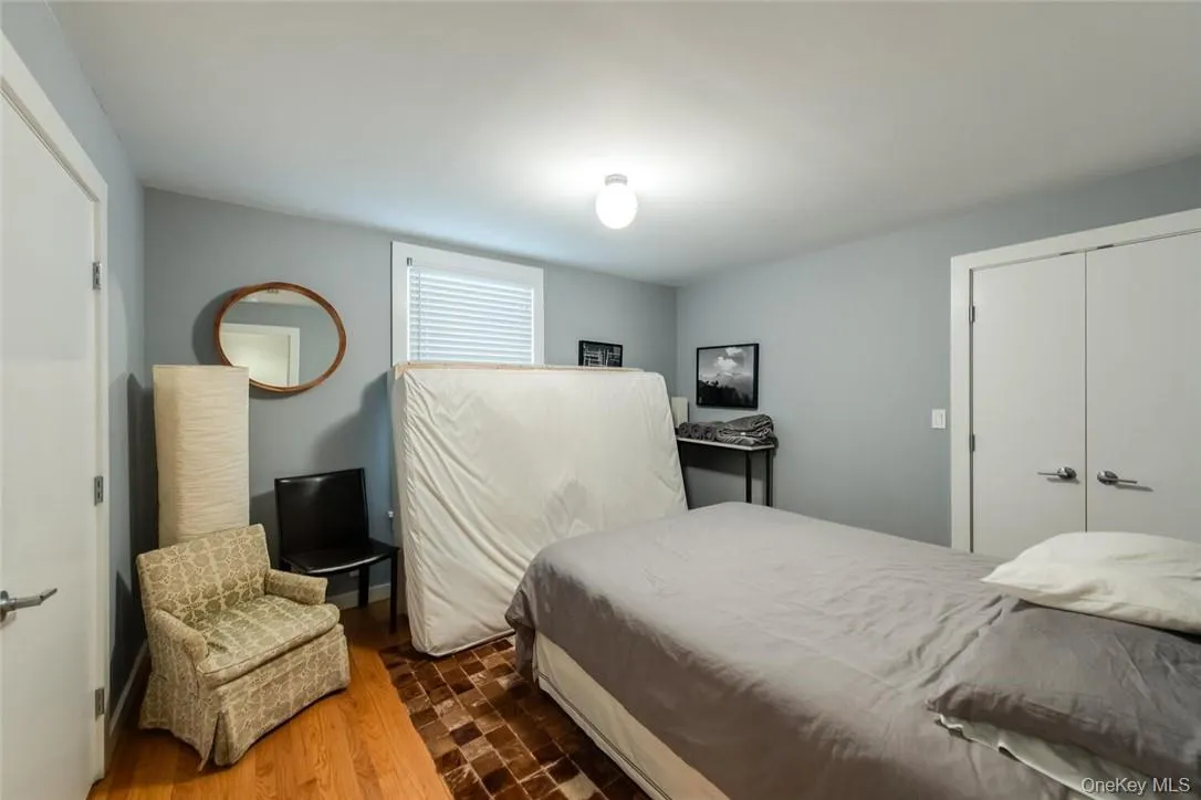Bedroom featuring hardwood / wood-style floors and a closet Bedroom featuring hardwood / wood-style floors and a closet