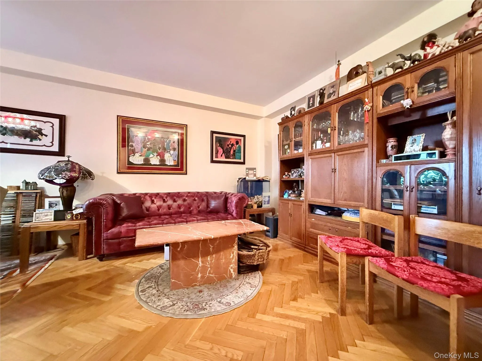 Elegant herringbone hardwood floors, open to the dining area that has a double panel window Elegant herringbone hardwood floors, open to the dining area that has a double panel window