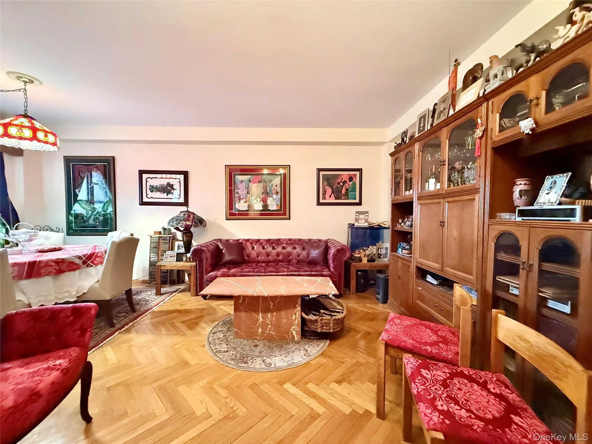 Elegant herringbone hardwood floors, open to the dining area that has a double panel window Elegant herringbone hardwood floors, open to the dining area that has a double panel window