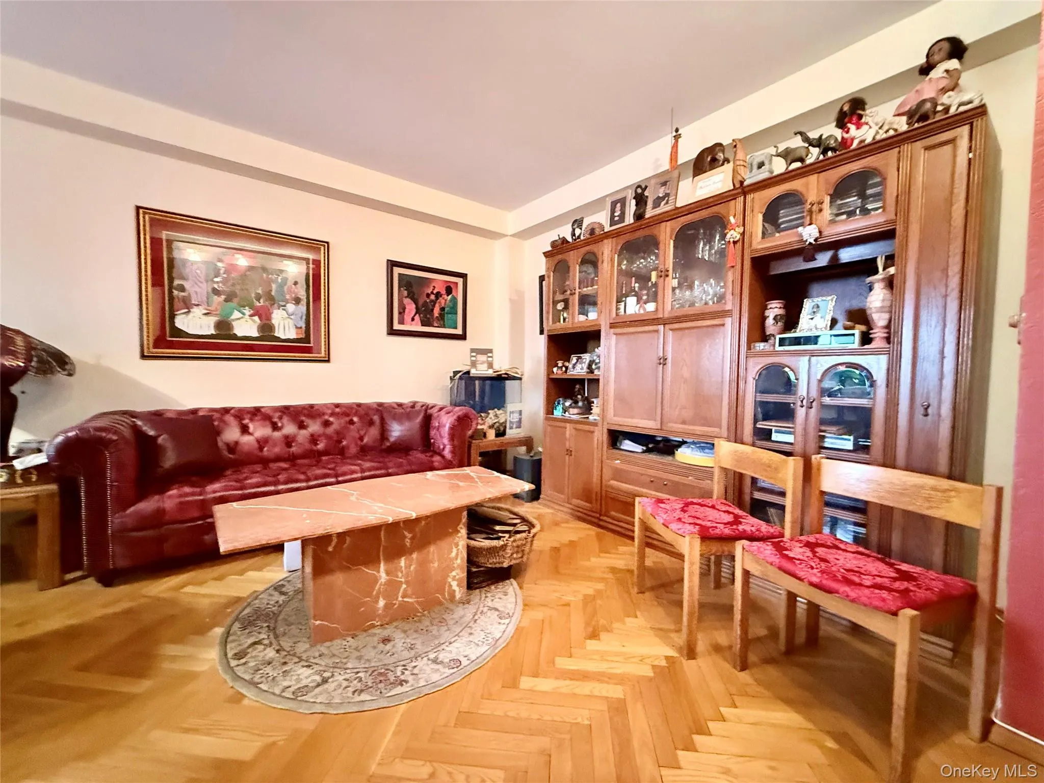 Elegant herringbone hardwood floors, open to the dining area that has a double panel window Elegant herringbone hardwood floors, open to the dining area that has a double panel window