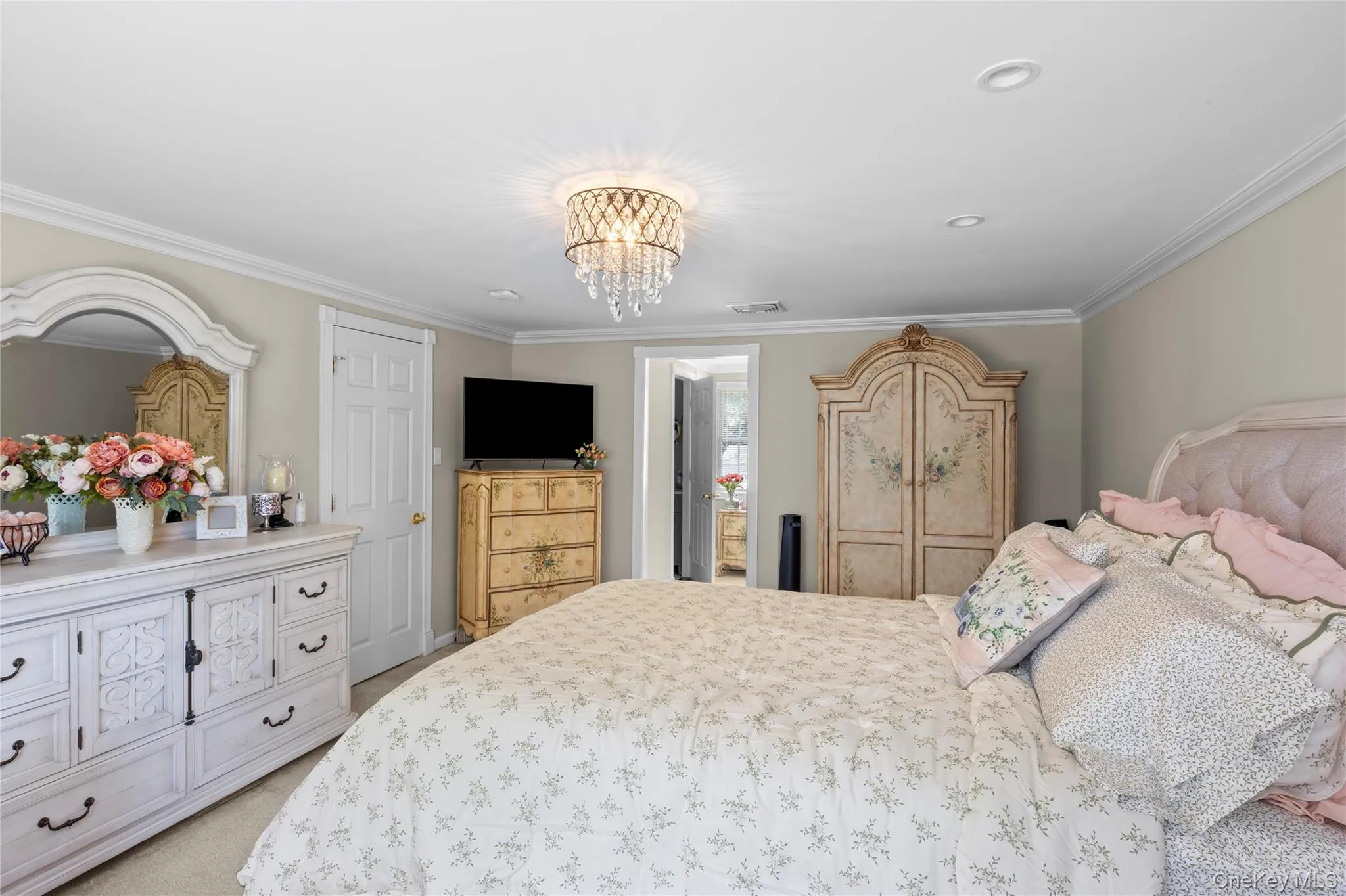 Bedroom featuring a crystal chandelier and recessed lighting Bedroom featuring a crystal chandelier and recessed lighting