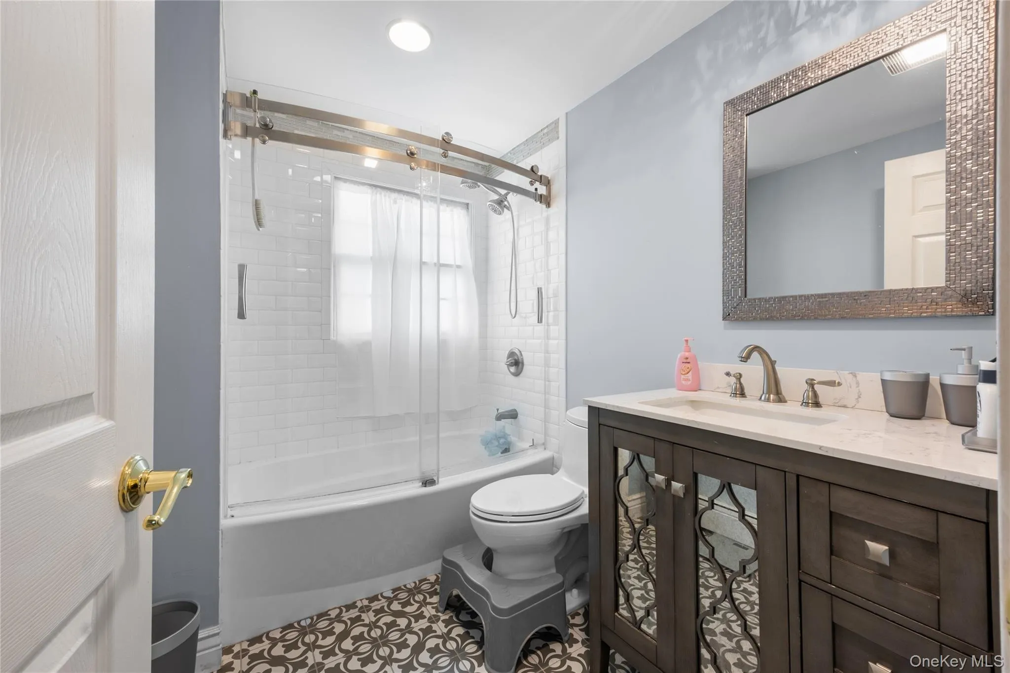 Contemporary bathroom featuring a dark wood-finish vanity with a stone countertop and an undermount sink Contemporary bathroom featuring a dark wood-finish vanity with a stone countertop and an undermount sink