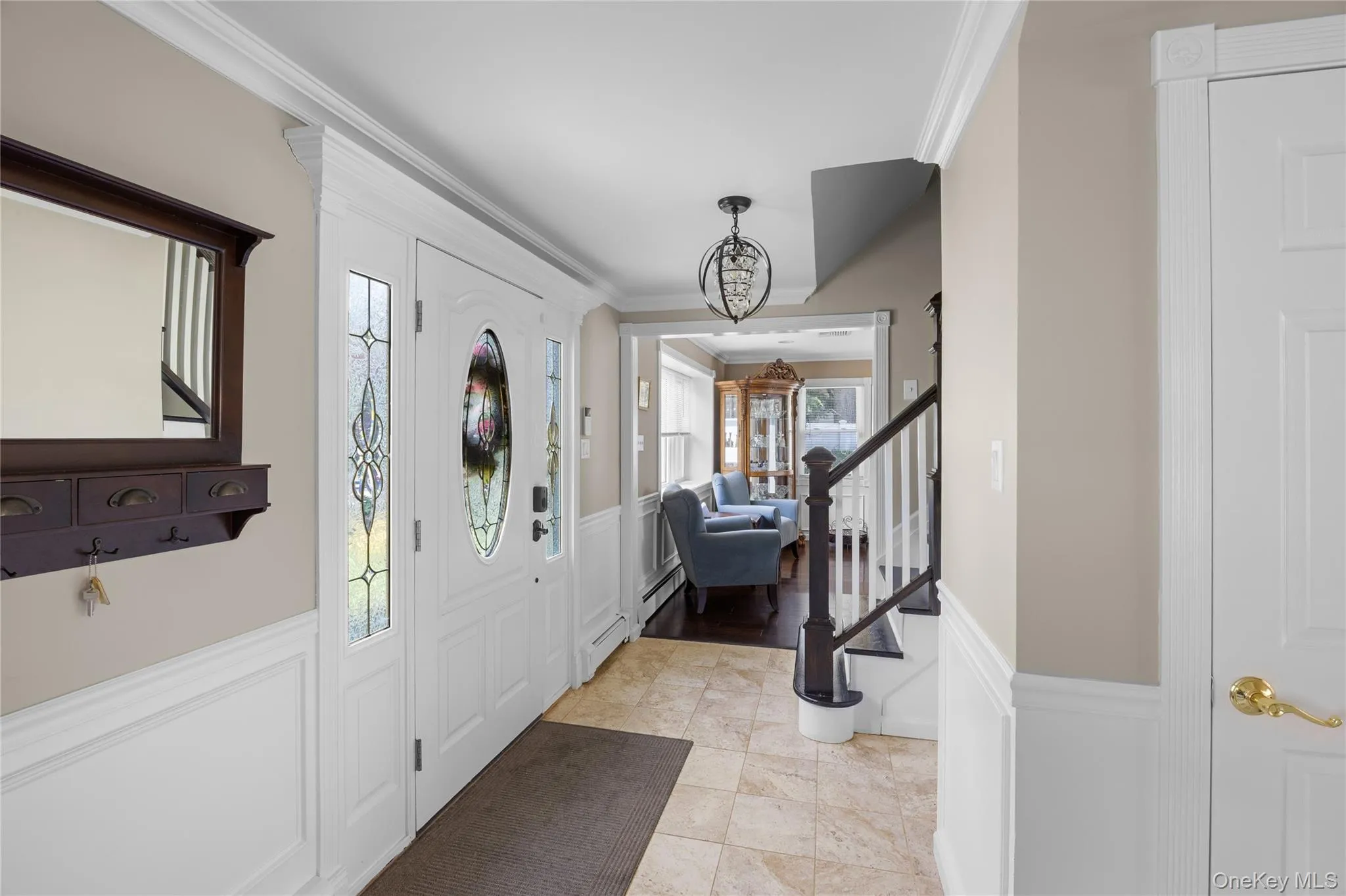 Entryway featuring a white paneled door with decorative glass inserts, sidelights, and a transom window Entryway featuring a white paneled door with decorative glass inserts, sidelights, and a transom window