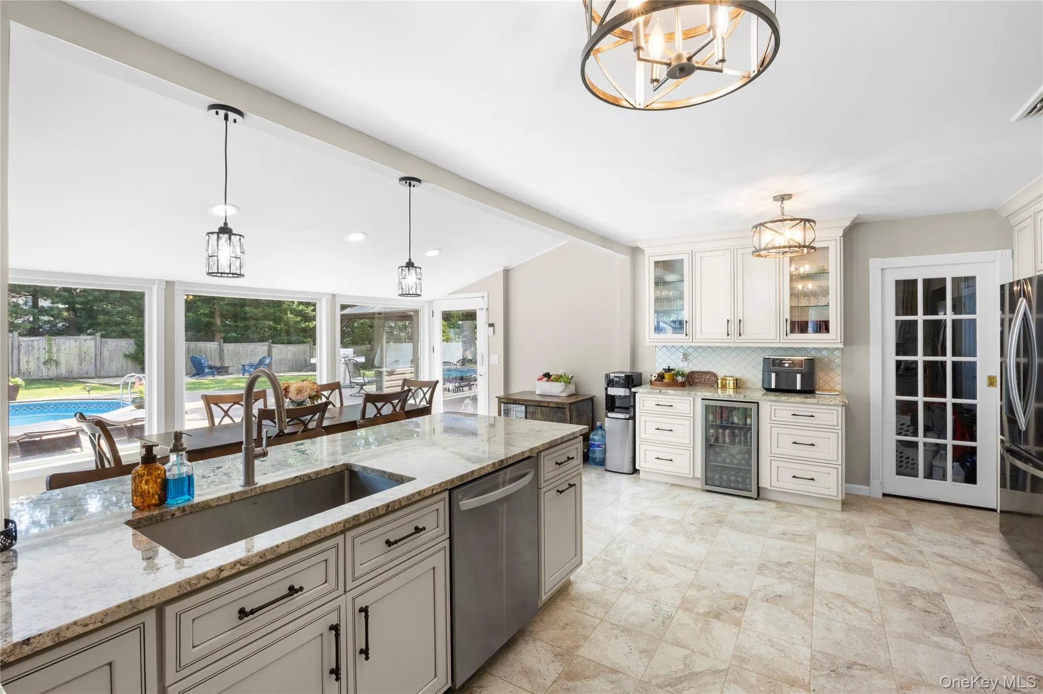 Spacious kitchen featuring a large island with an undermount sink and stainless steel dishwasher Spacious kitchen featuring a large island with an undermount sink and stainless steel dishwasher