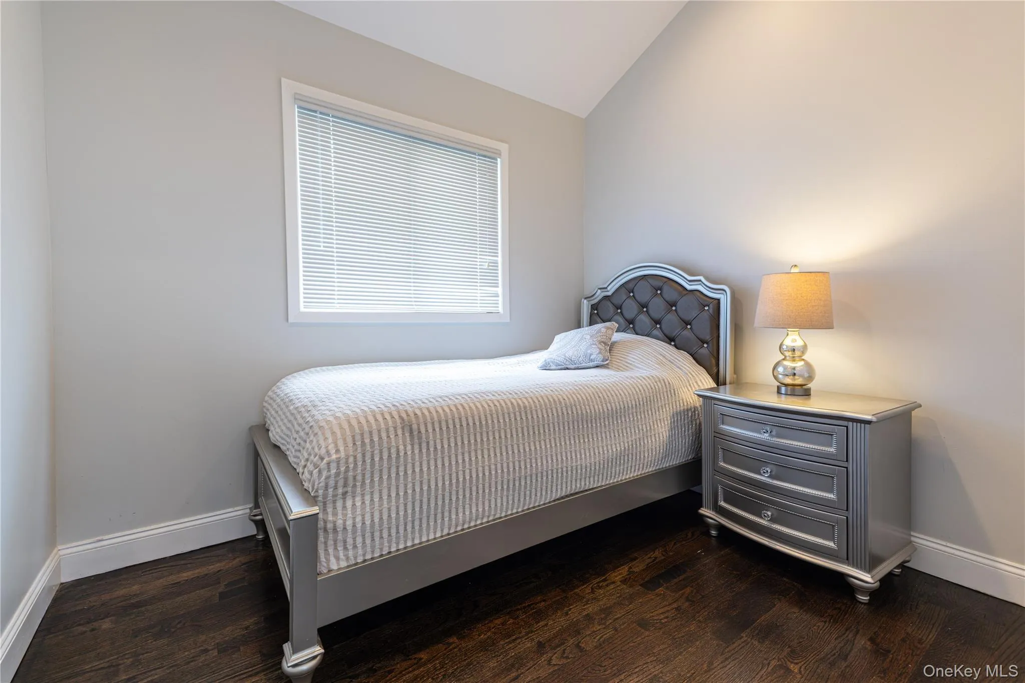 Bedroom featuring dark wood-finish flooring. Bedroom featuring dark wood-finish flooring.