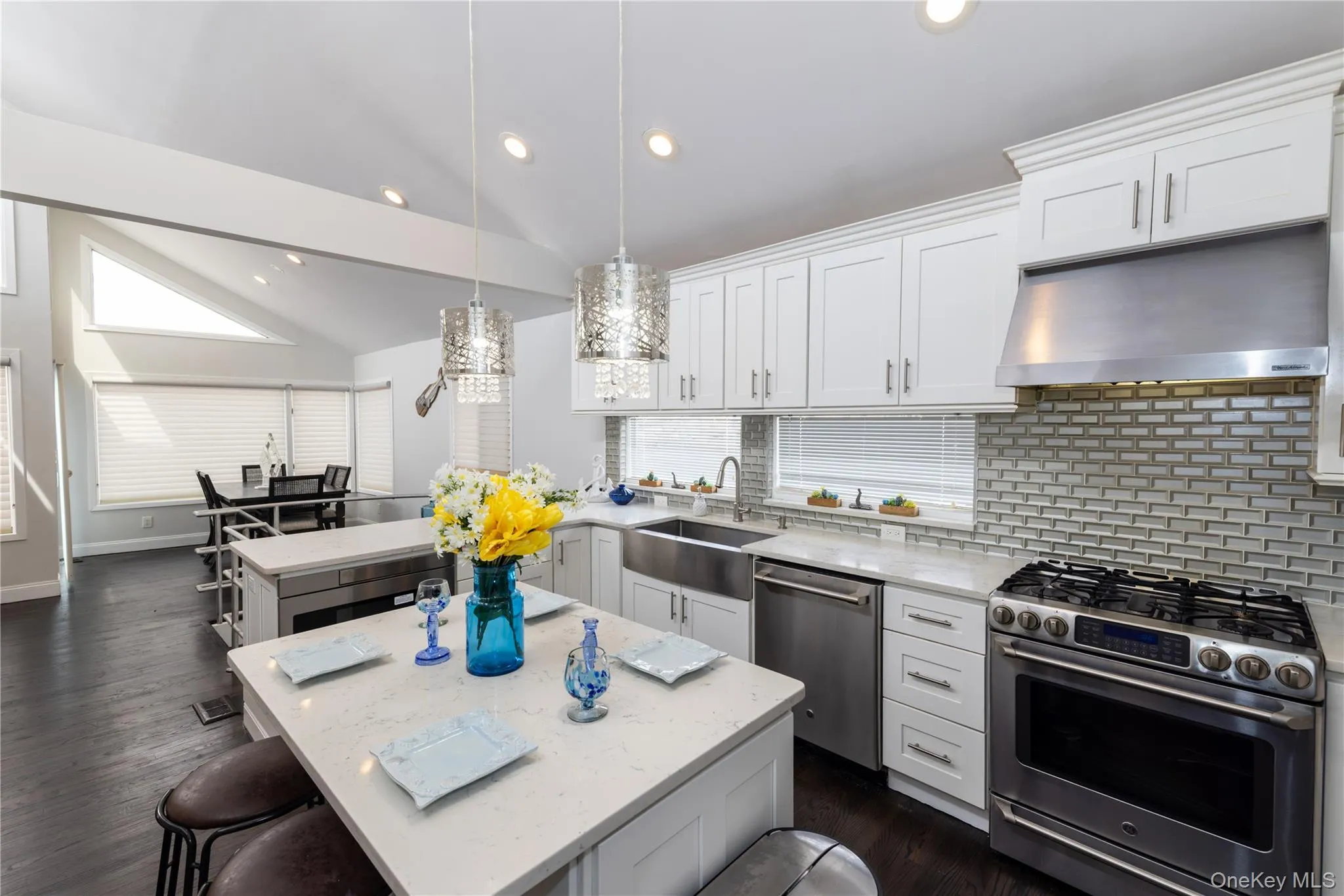 Contemporary kitchen featuring white cabinetry and stainless-steel appliances Contemporary kitchen featuring white cabinetry and stainless-steel appliances