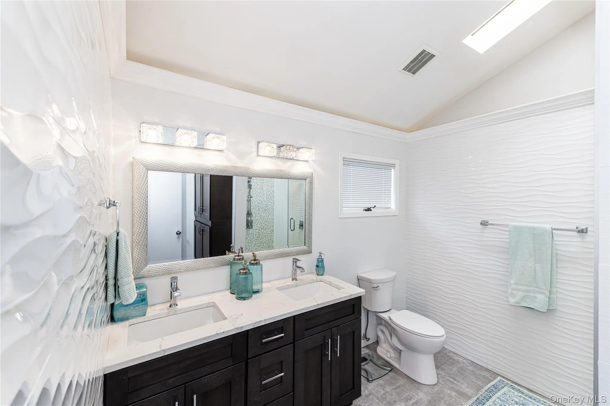 Bathroom featuring a double vanity. Bathroom featuring a double vanity.