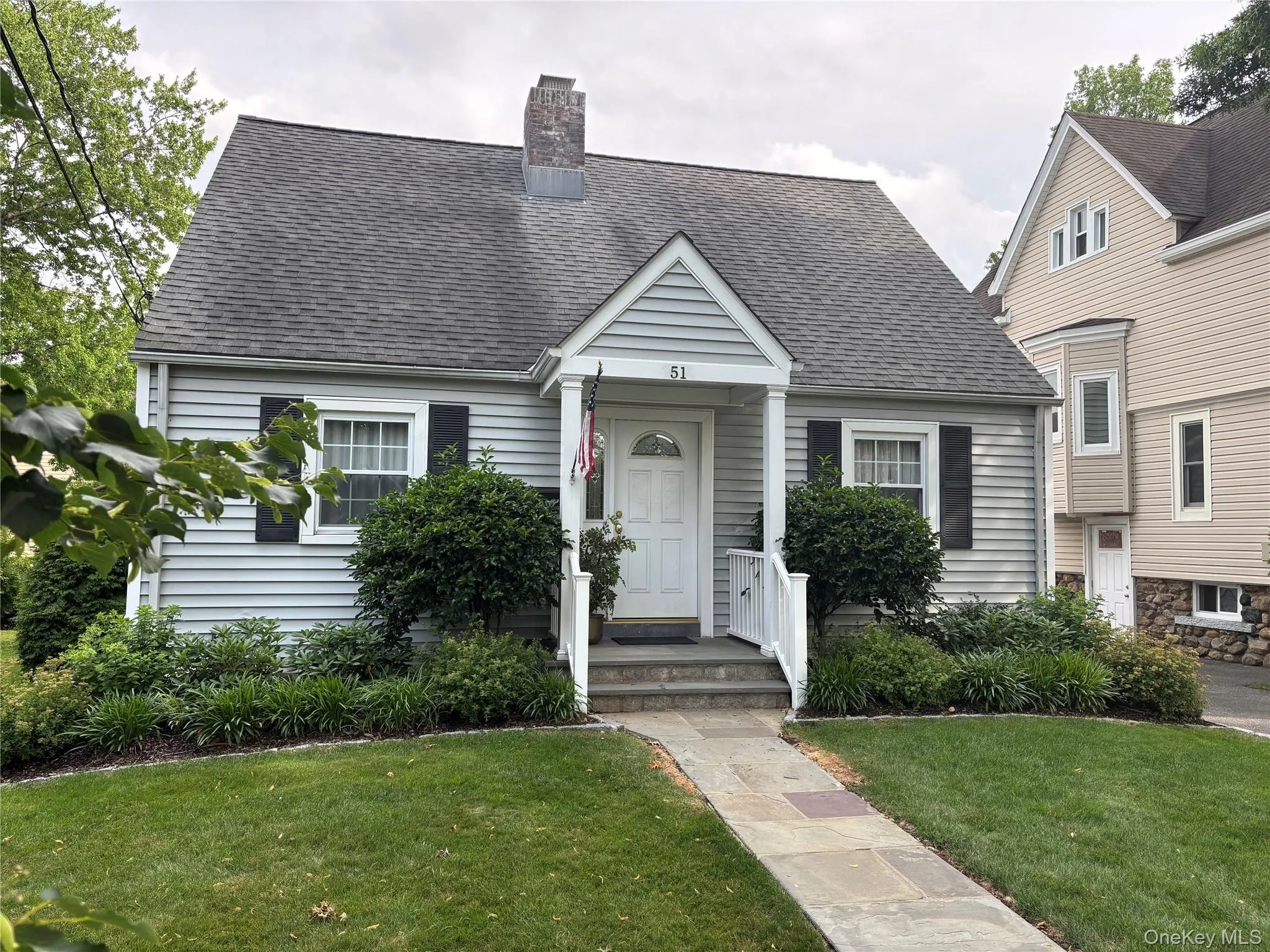 Light gray siding exterior with dark shutters Light gray siding exterior with dark shutters