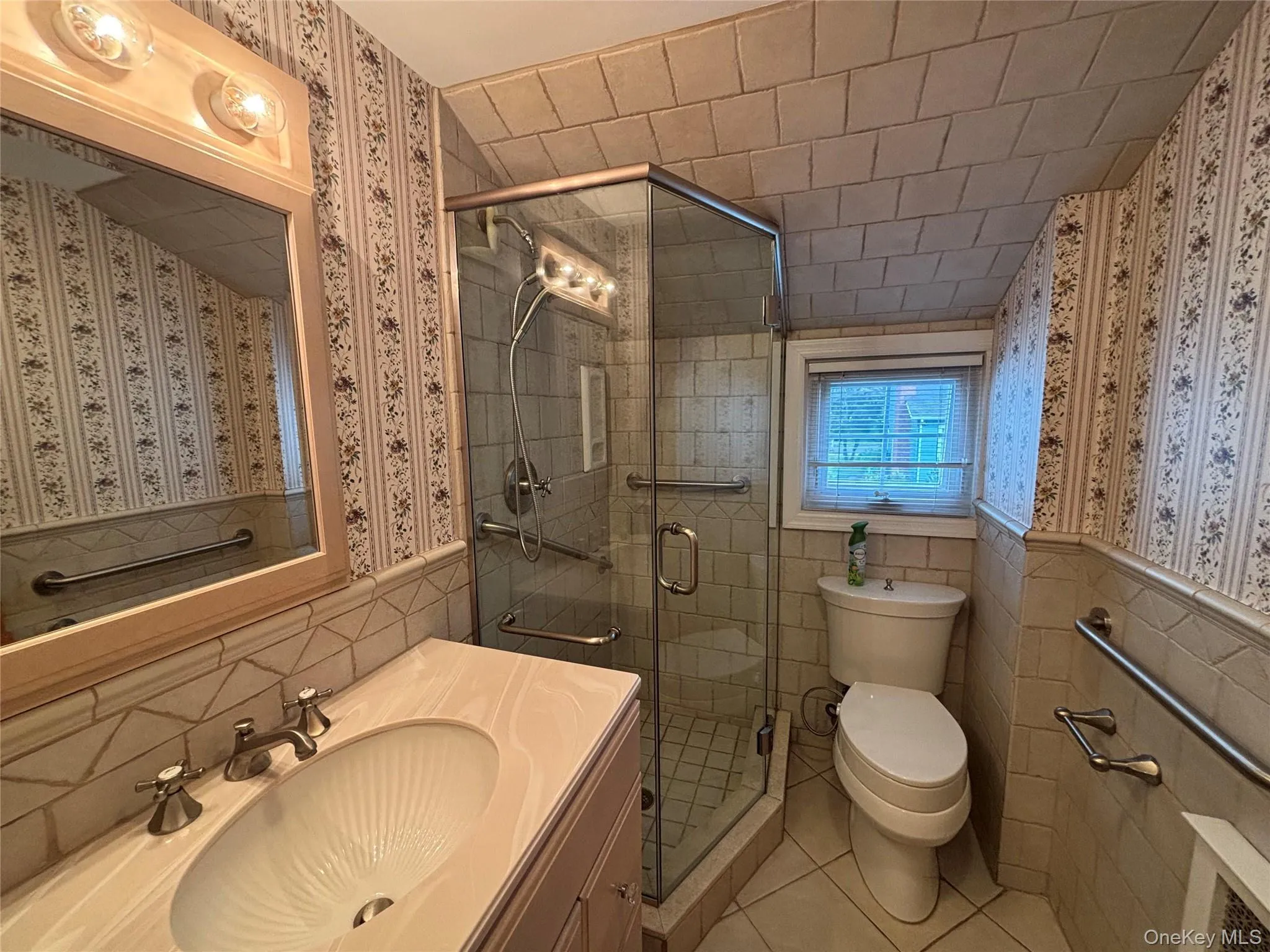 Bathroom featuring a glass-enclosed shower, a vanity with a built-in sink, and a tiled ceiling Bathroom featuring a glass-enclosed shower, a vanity with a built-in sink, and a tiled ceiling