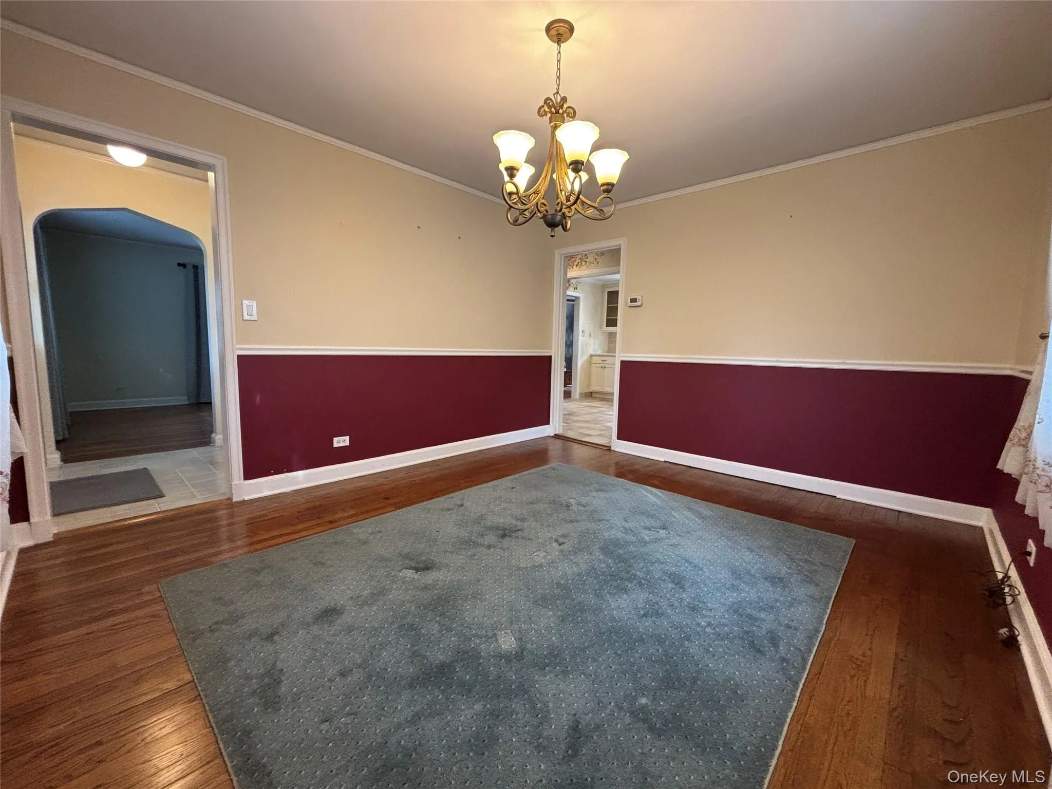 Hardwood flooring throughout, featuring a five-light chandelier Hardwood flooring throughout, featuring a five-light chandelier