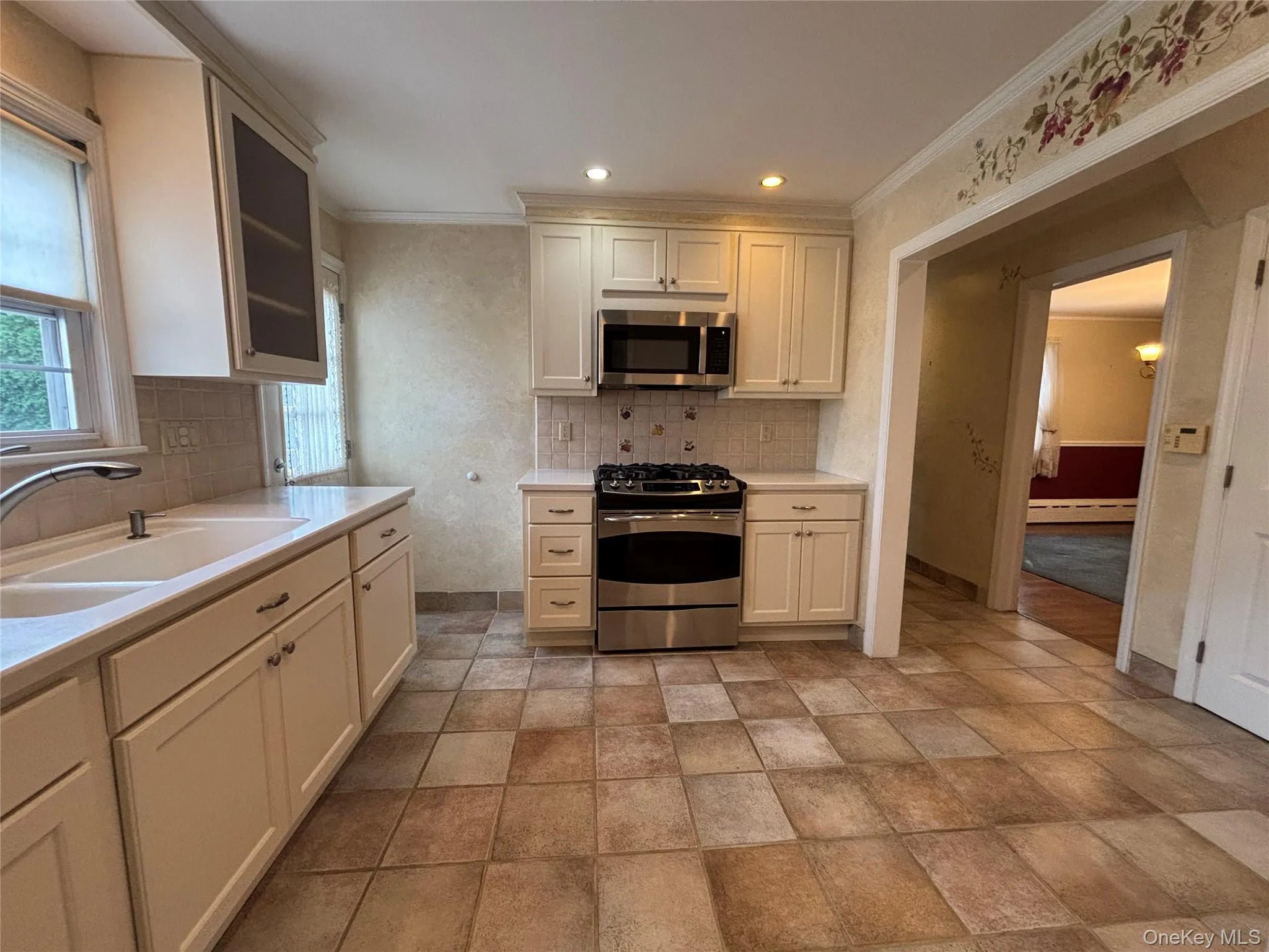 Eat-in kitchen featuring durable tile flooring, recessed lighting, and ample cabinetry with modern hardware Eat-in kitchen featuring durable tile flooring, recessed lighting, and ample cabinetry with modern hardware