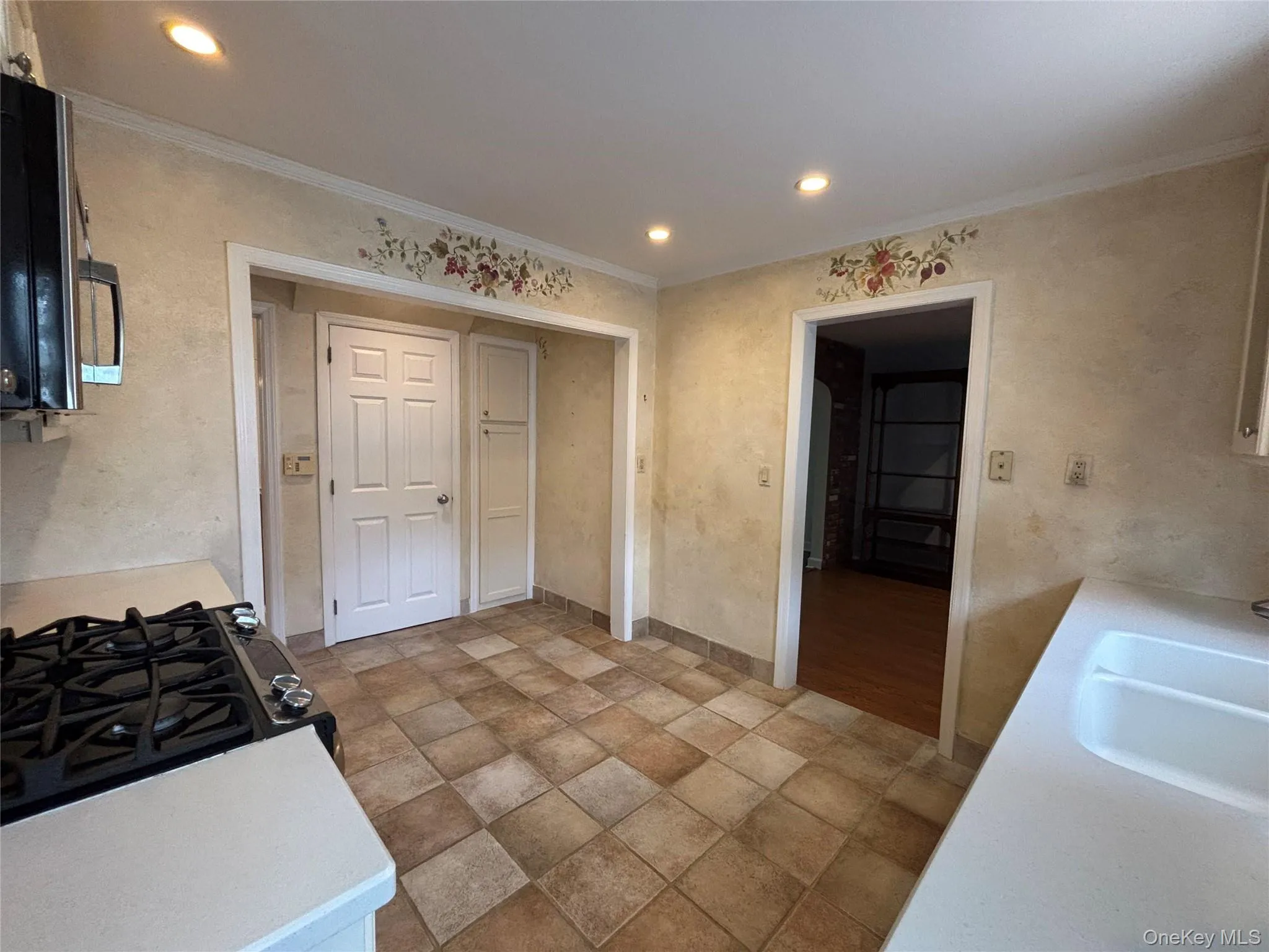 Kitchen area featuring tiled flooring, recessed lighting, a built-in gas range, and a dual-basin sink Kitchen area featuring tiled flooring, recessed lighting, a built-in gas range, and a dual-basin sink