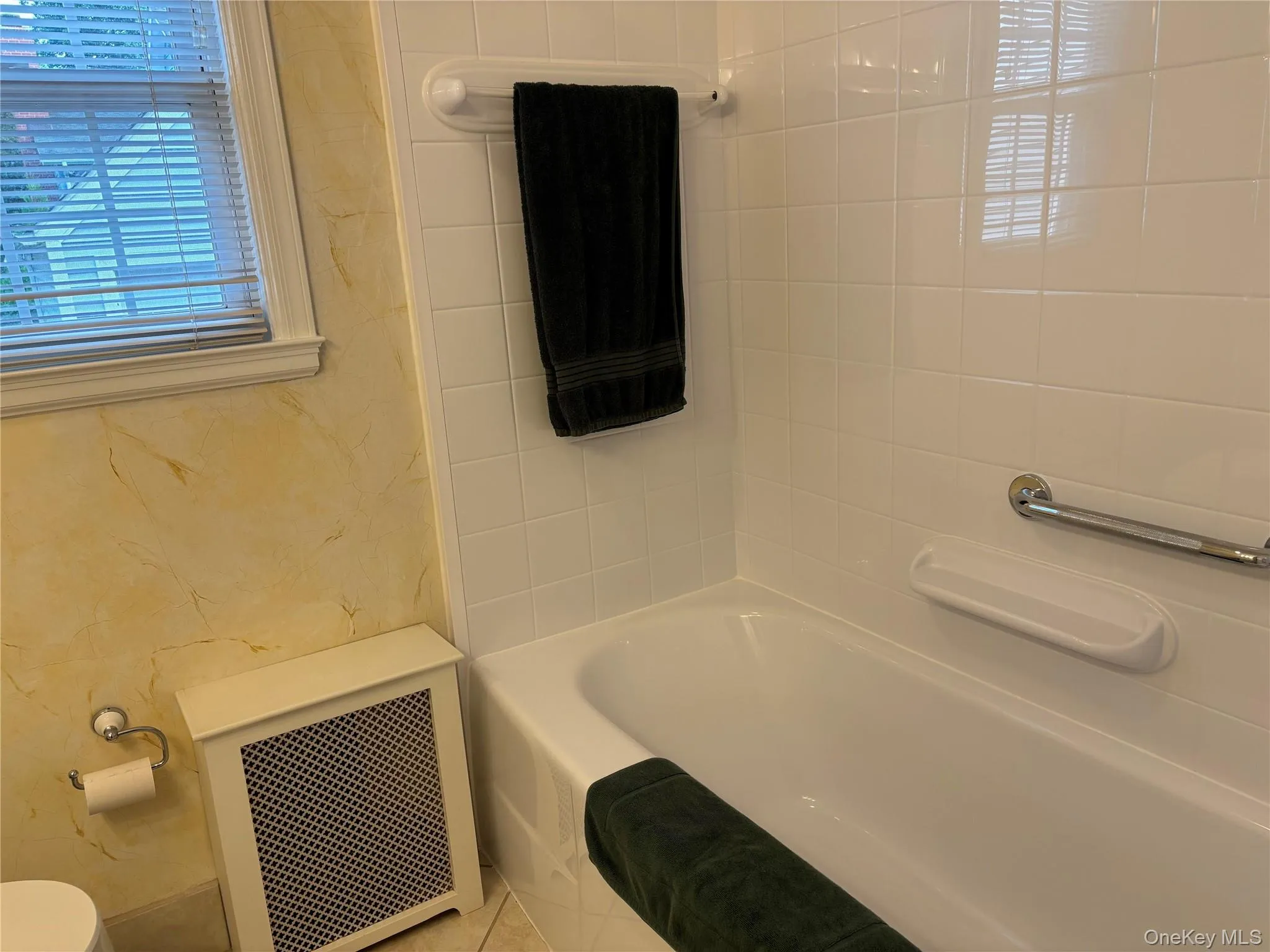 White subway tile shower surround with a built-in tub White subway tile shower surround with a built-in tub