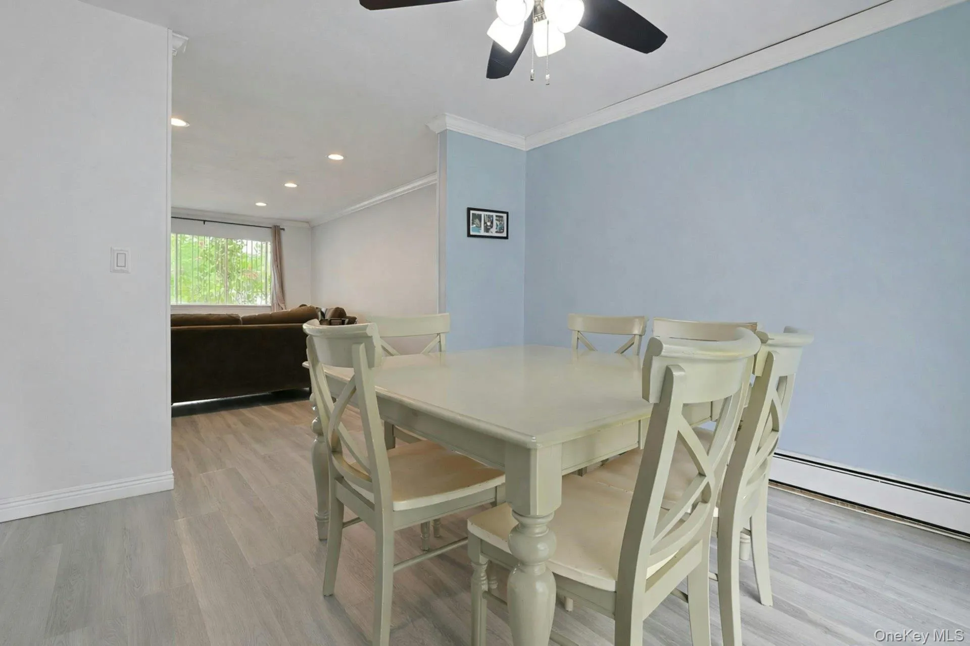 The dining room, with a convenient ceiling fan, is open to the living room and kitchen. The dining room, with a convenient ceiling fan, is open to the living room and kitchen.