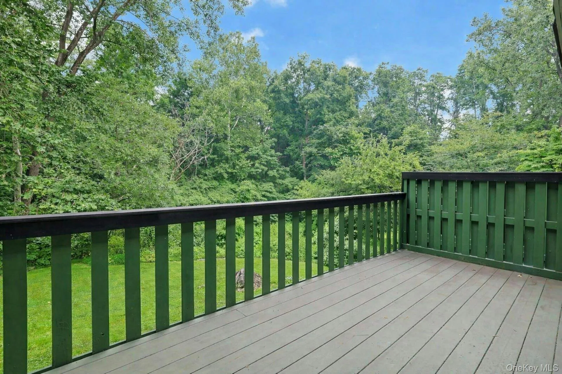 The back deck looks out to the peaceful, wooded area that frames the rear of the home. The back deck looks out to the peaceful, wooded area that frames the rear of the home.