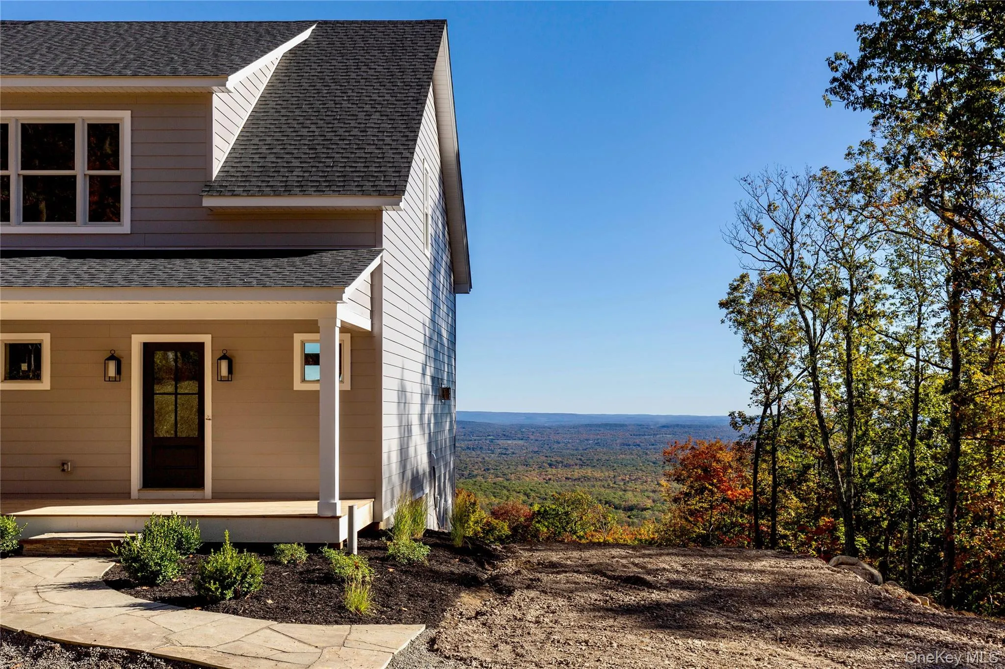 View of home's exterior featuring roof with shingles and a porch View of home's exterior featuring roof with shingles and a porch