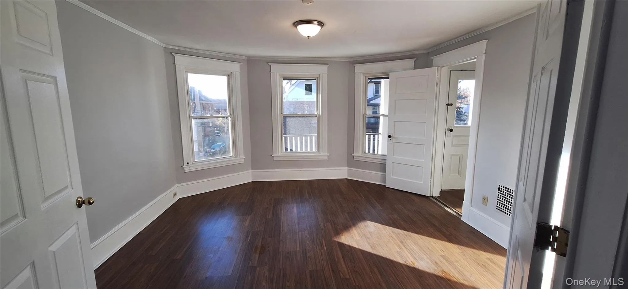 Foyer entrance with light vinyl wood-type flooring and ornamental molding Foyer entrance with light vinyl wood-type flooring and ornamental molding