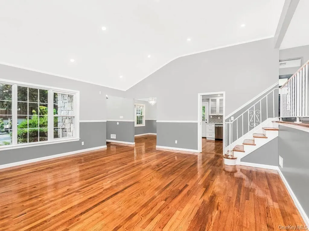 Vaulted ceilings featuring recessed lighting and robust wood-finish flooring Vaulted ceilings featuring recessed lighting and robust wood-finish flooring