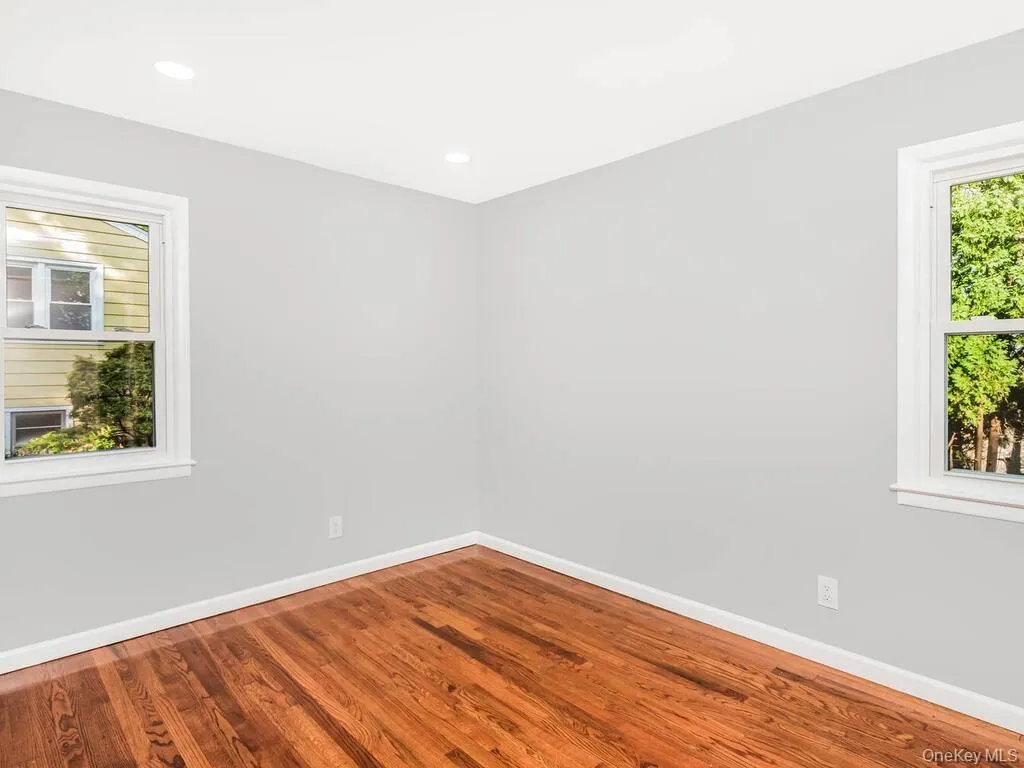 Hardwood flooring featured throughout this room with light gray walls Hardwood flooring featured throughout this room with light gray walls