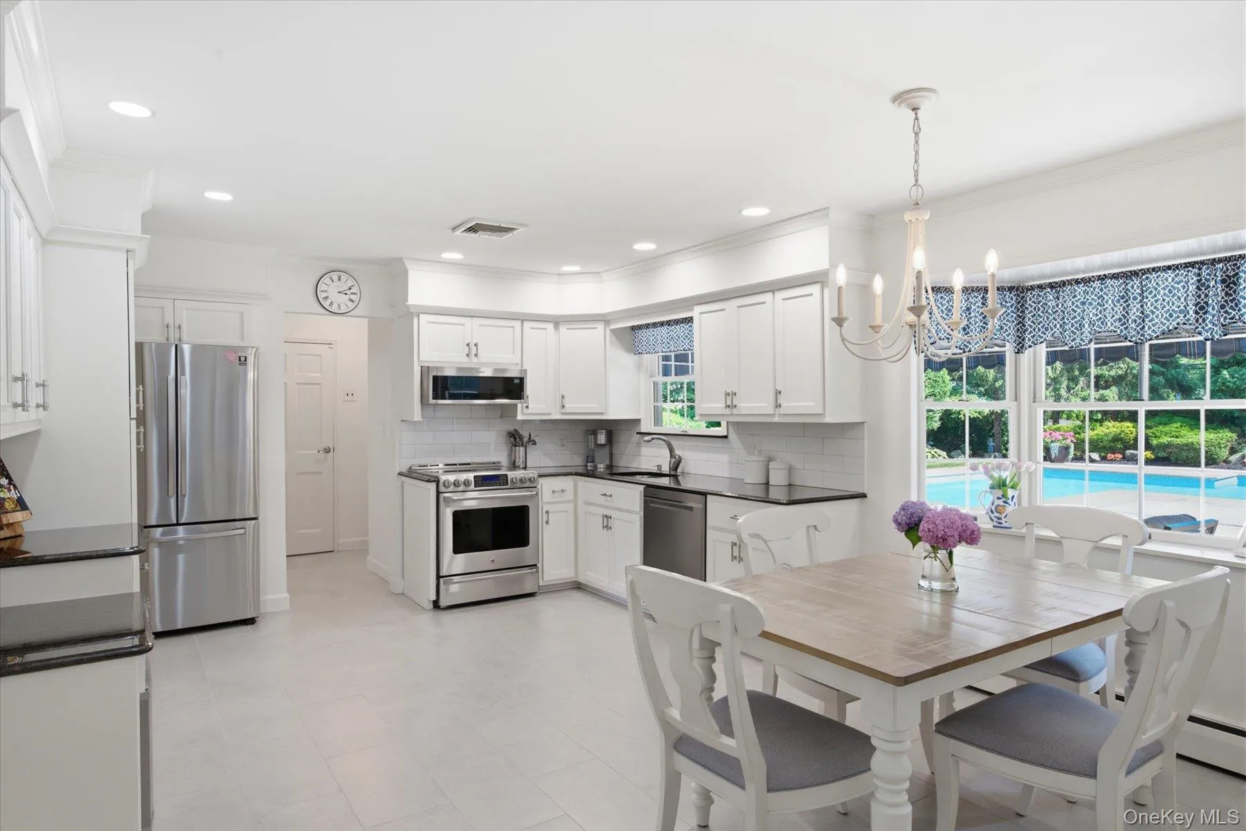 Spacious kitchen with a functional layout and casual dining area Spacious kitchen with a functional layout and casual dining area