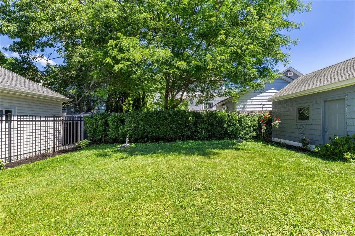 Expansive green lawn bounded by a mature hedge Expansive green lawn bounded by a mature hedge