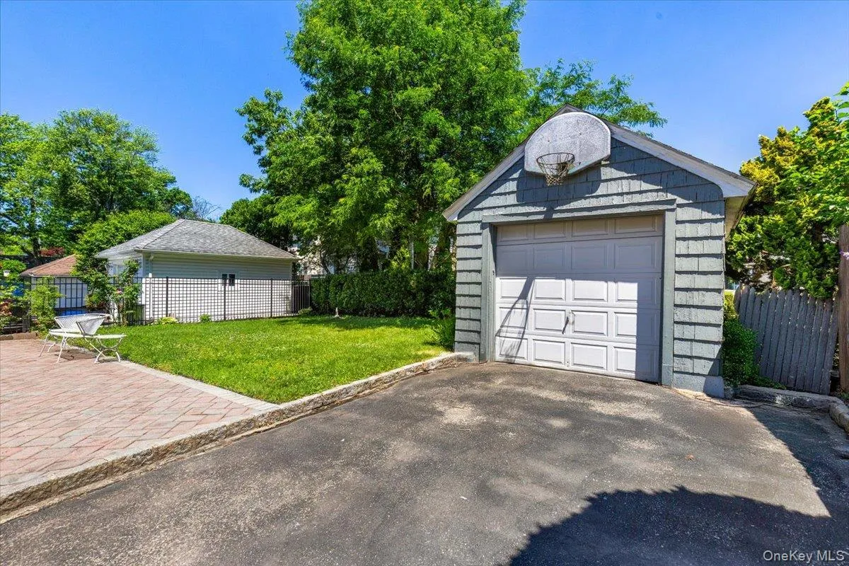 Detached garage with horizontal siding and an asphalt driveway Detached garage with horizontal siding and an asphalt driveway
