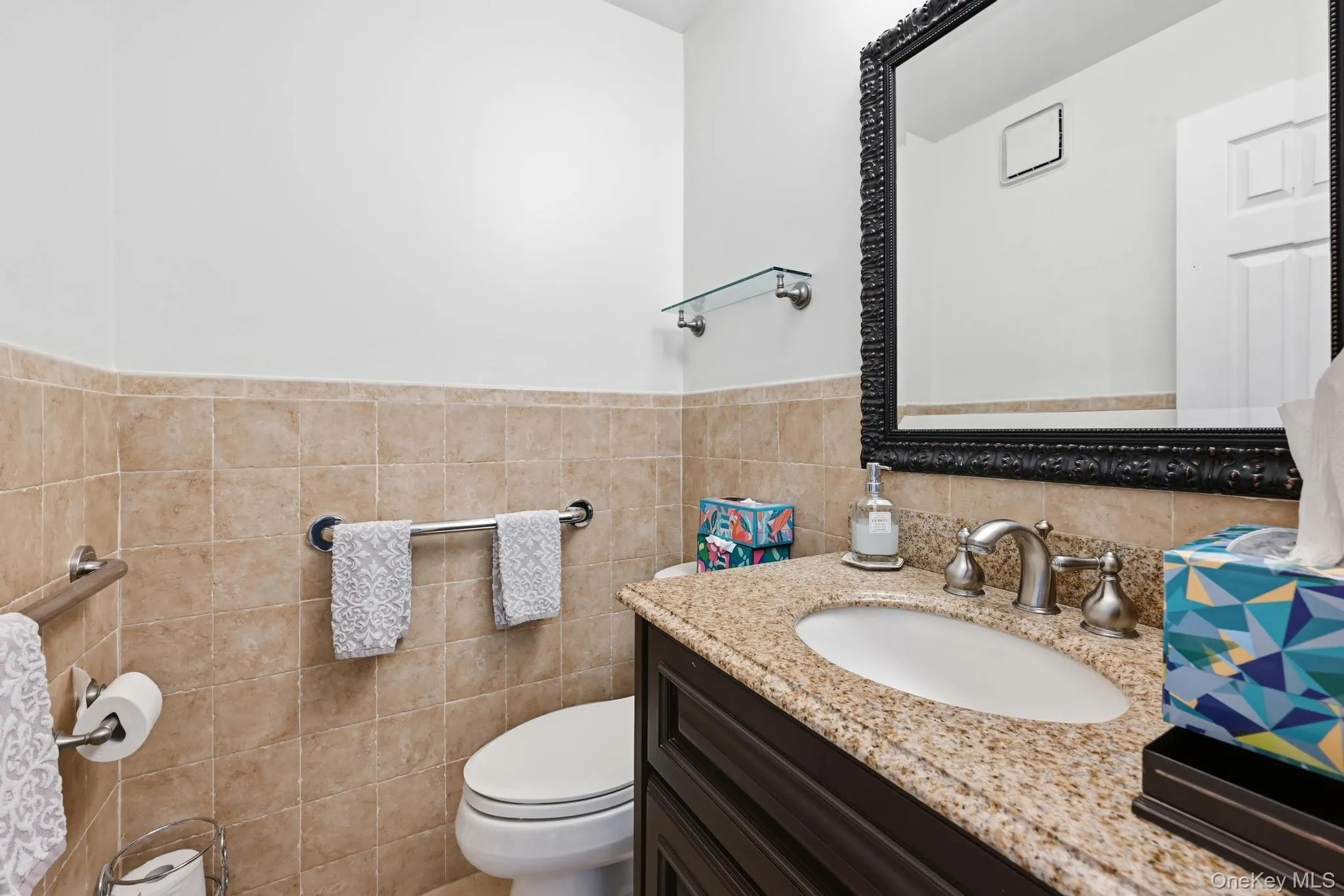 Vanity featuring a polished stone countertop, undermount sink, and brushed nickel faucet Vanity featuring a polished stone countertop, undermount sink, and brushed nickel faucet