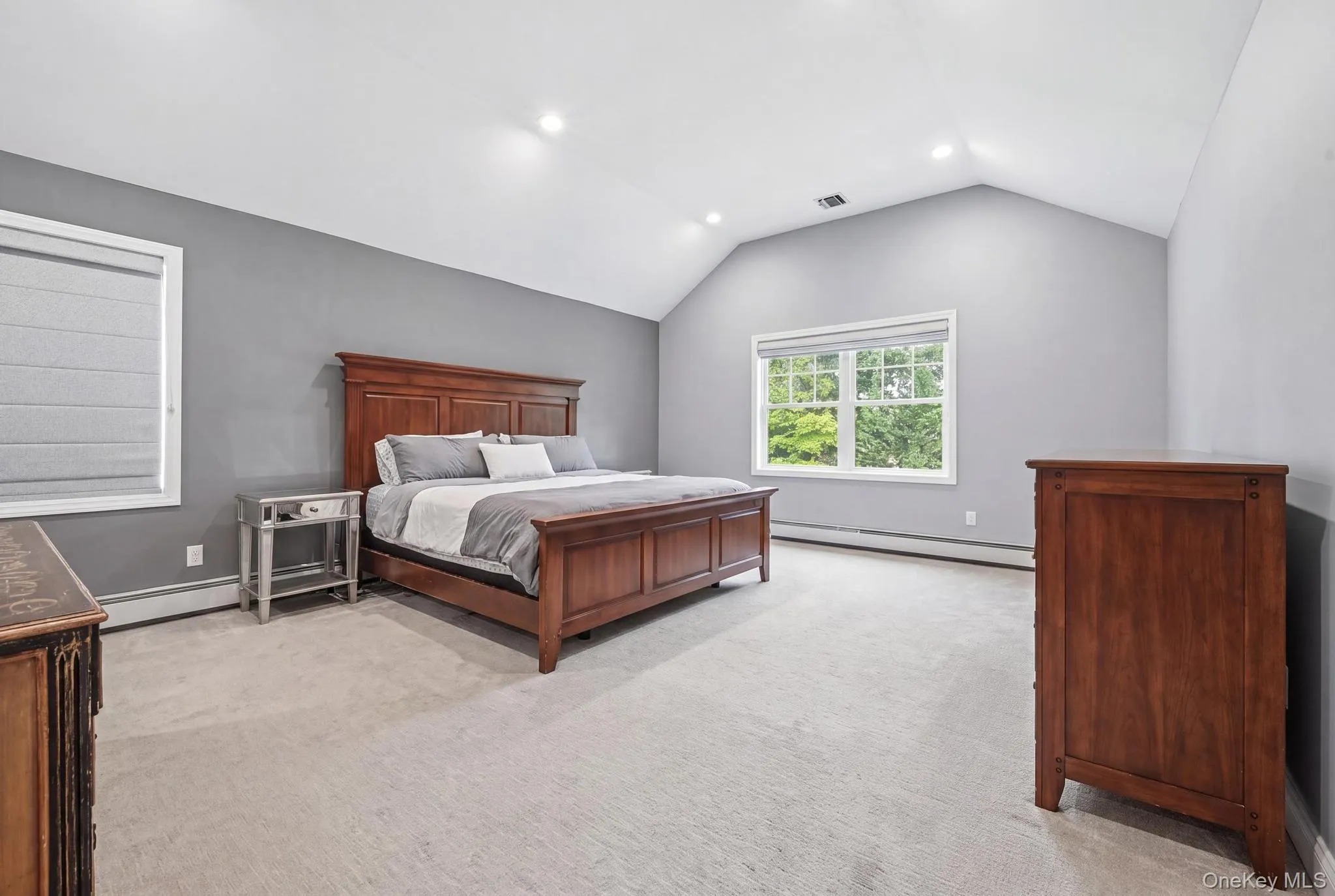 Room with vaulted ceiling, recessed lighting, and light-toned carpeting Room with vaulted ceiling, recessed lighting, and light-toned carpeting