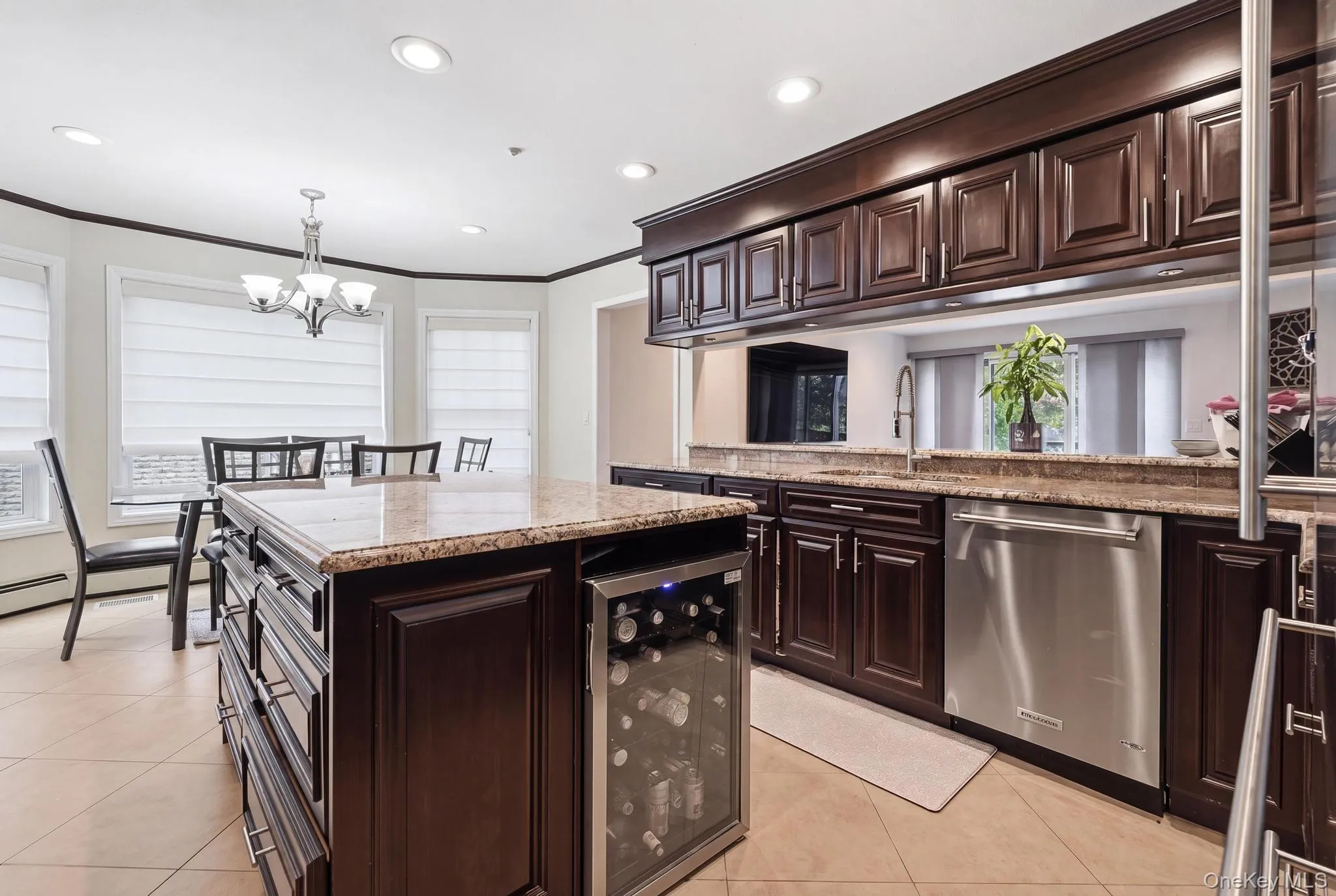Gourmet kitchen featuring dark wood cabinetry, granite countertops, and stainless steel appliances Gourmet kitchen featuring dark wood cabinetry, granite countertops, and stainless steel appliances