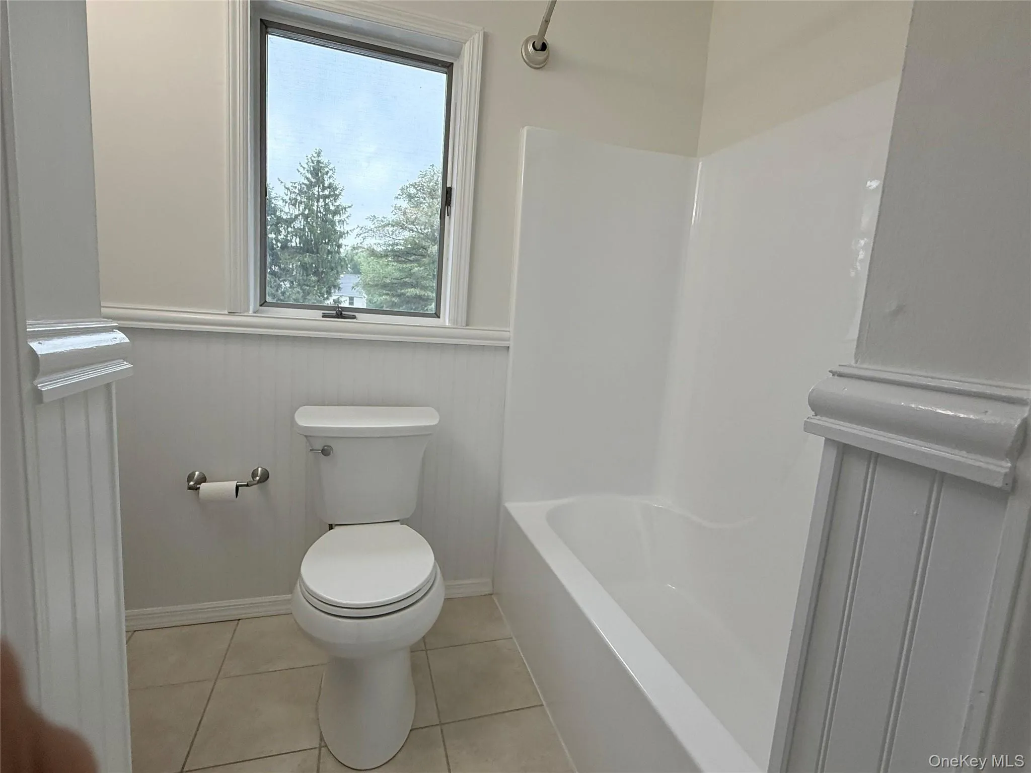 The bathroom is fresh and airy featuring a window that brings in natural light and offers a pleasant outdoor view. The bathroom is fresh and airy featuring a window that brings in natural light and offers a pleasant outdoor view.