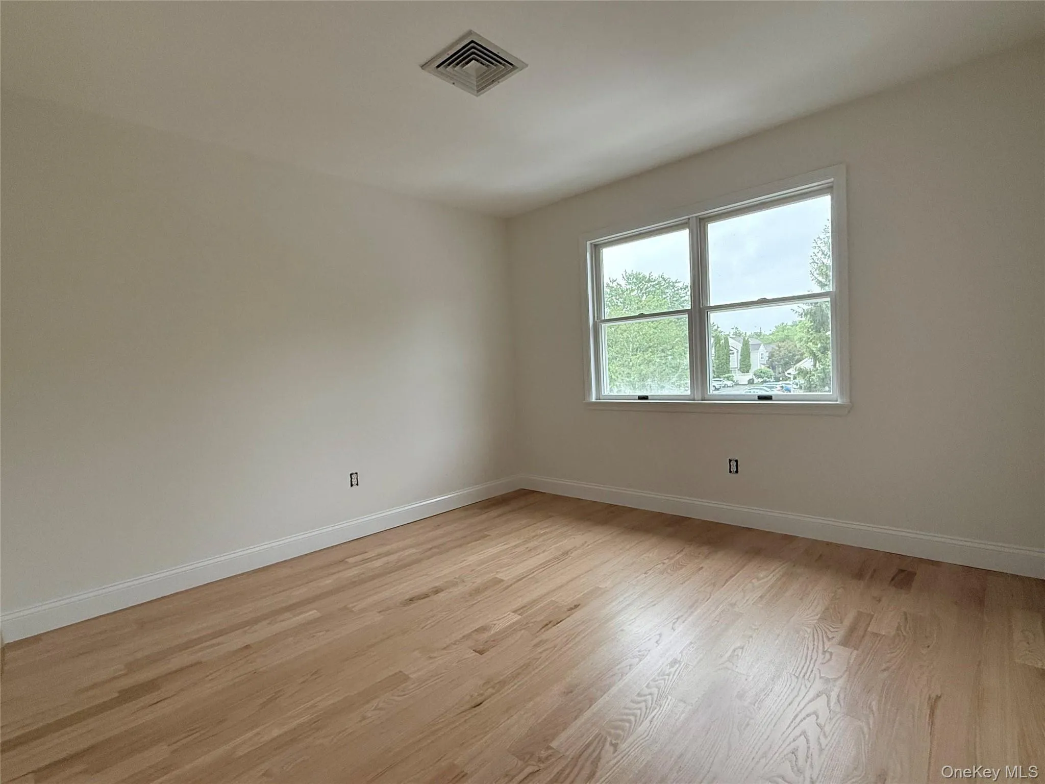 A bright second bedroom, ideal for guests, a home office, or additional living space. A bright second bedroom, ideal for guests, a home office, or additional living space.