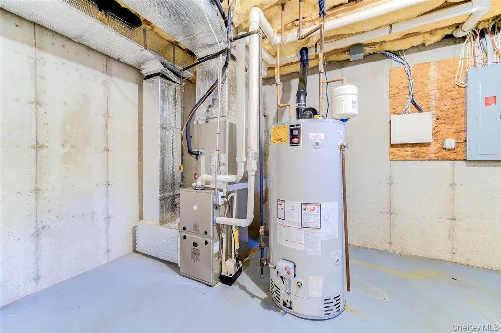 Newly purchased (2025) hot water heater and A/C Unit in unfinished basement. Newly purchased (2025) hot water heater and A/C Unit in unfinished basement.