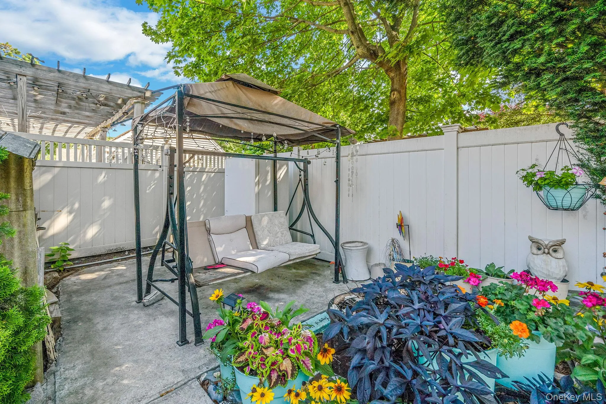 Fenced backyard with a patio area and a gazebo Fenced backyard with a patio area and a gazebo