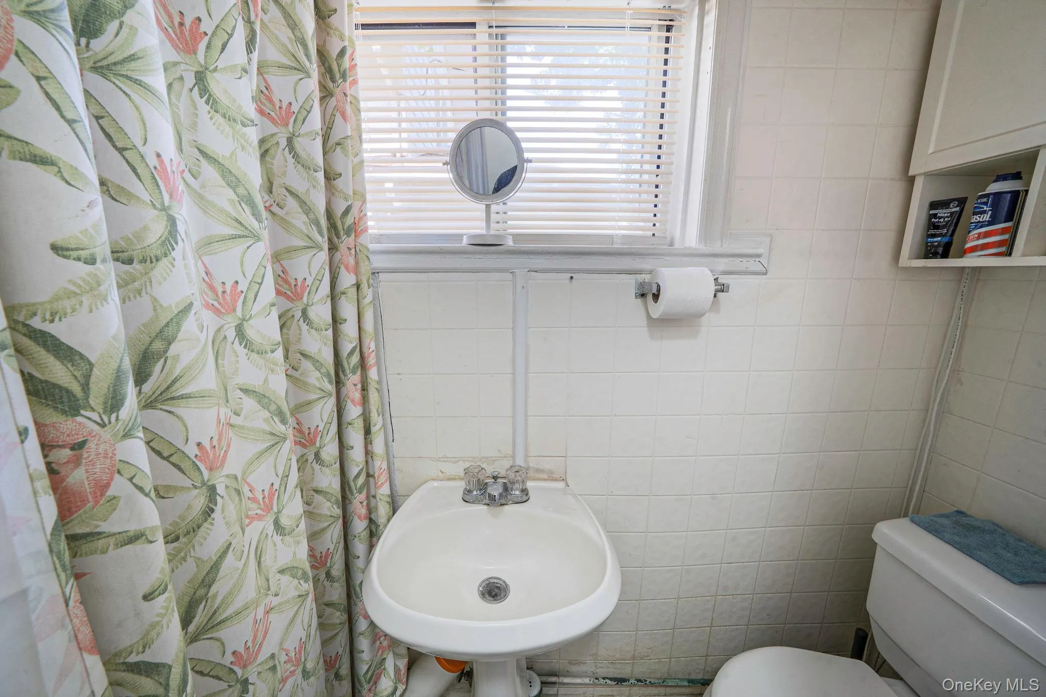 Bathroom featuring tile walls and curtained shower Bathroom featuring tile walls and curtained shower