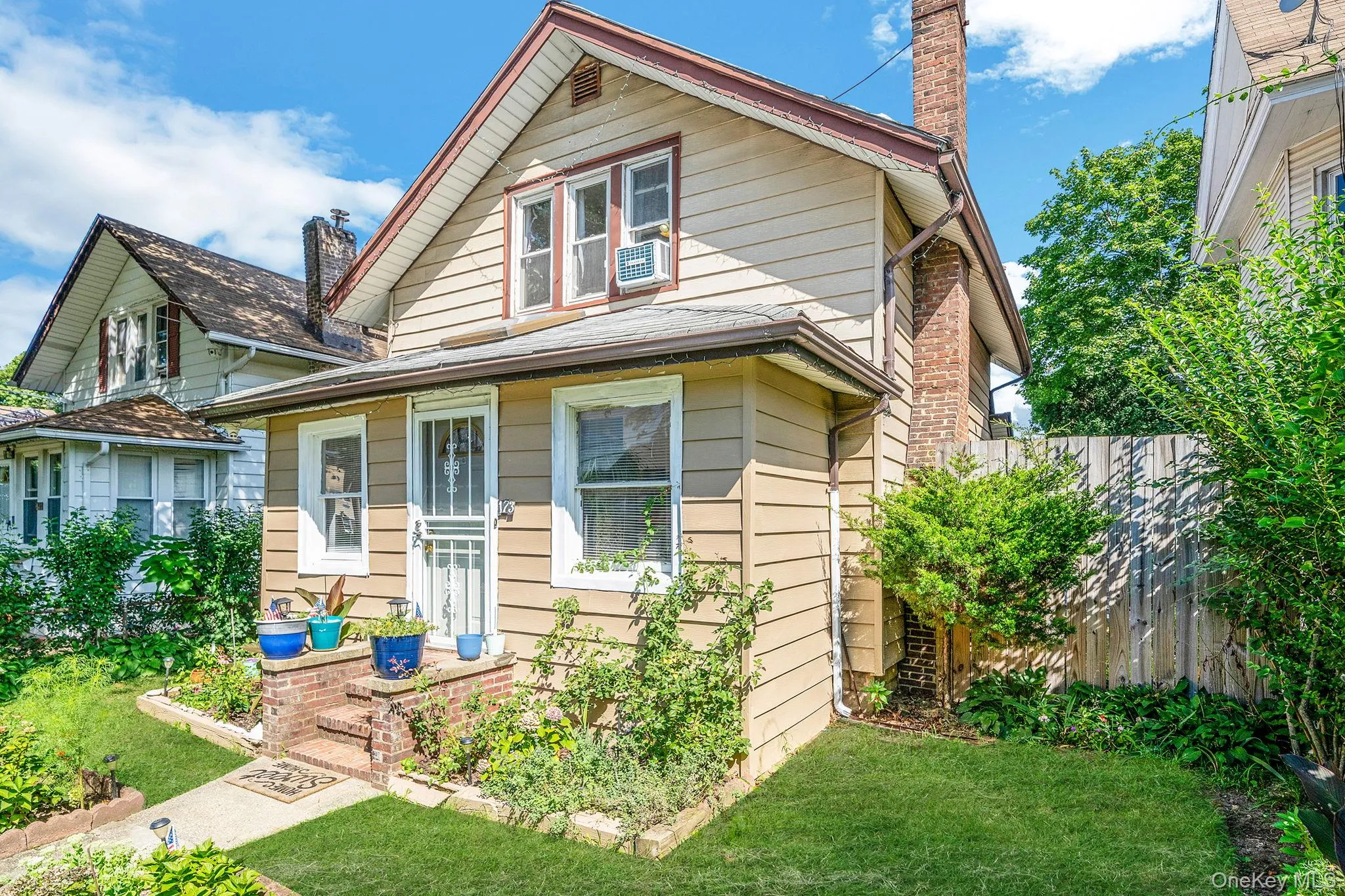 Bungalow with a chimney and brick siding Bungalow with a chimney and brick siding