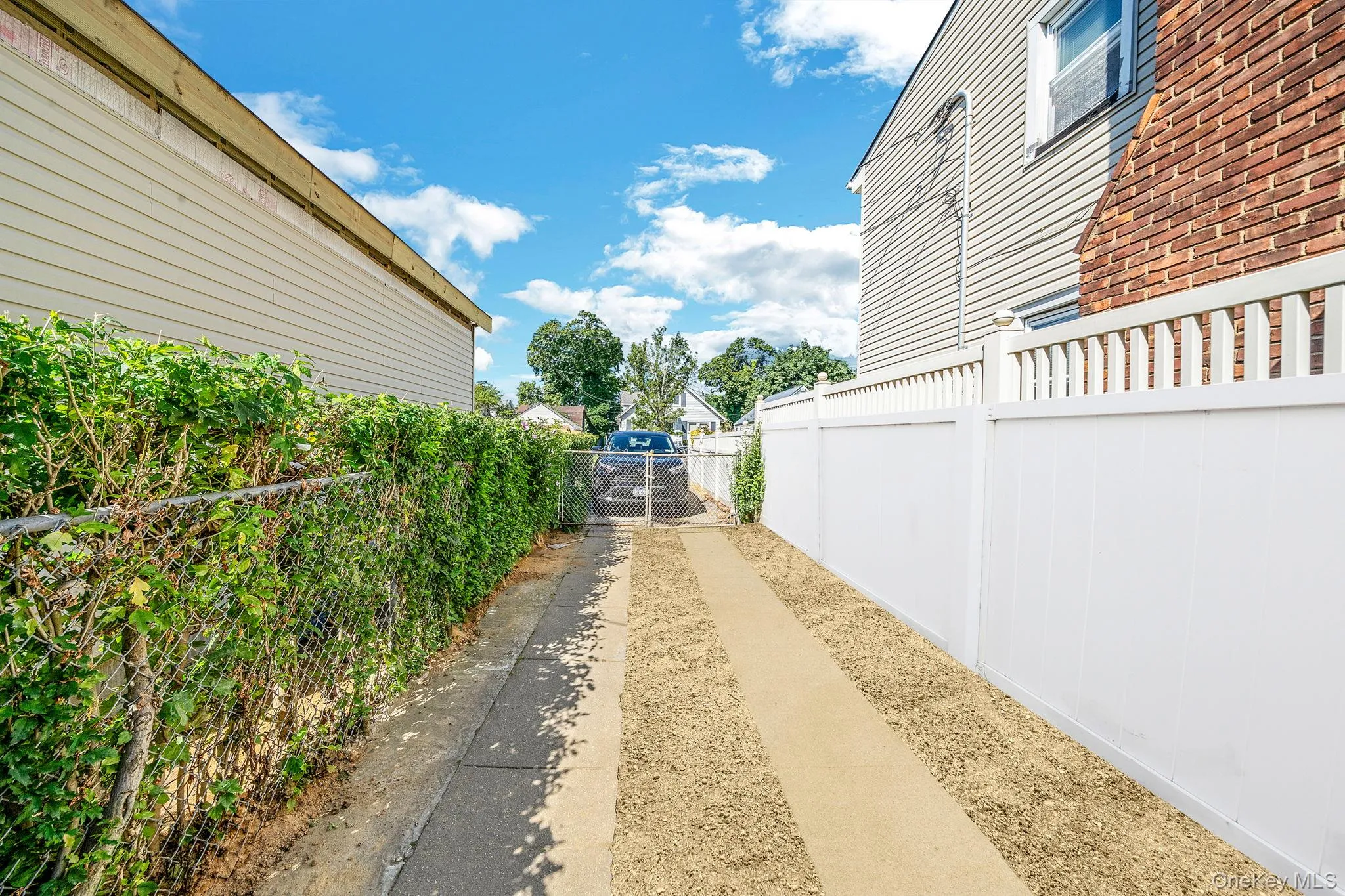 View of side of home with a gate View of side of home with a gate