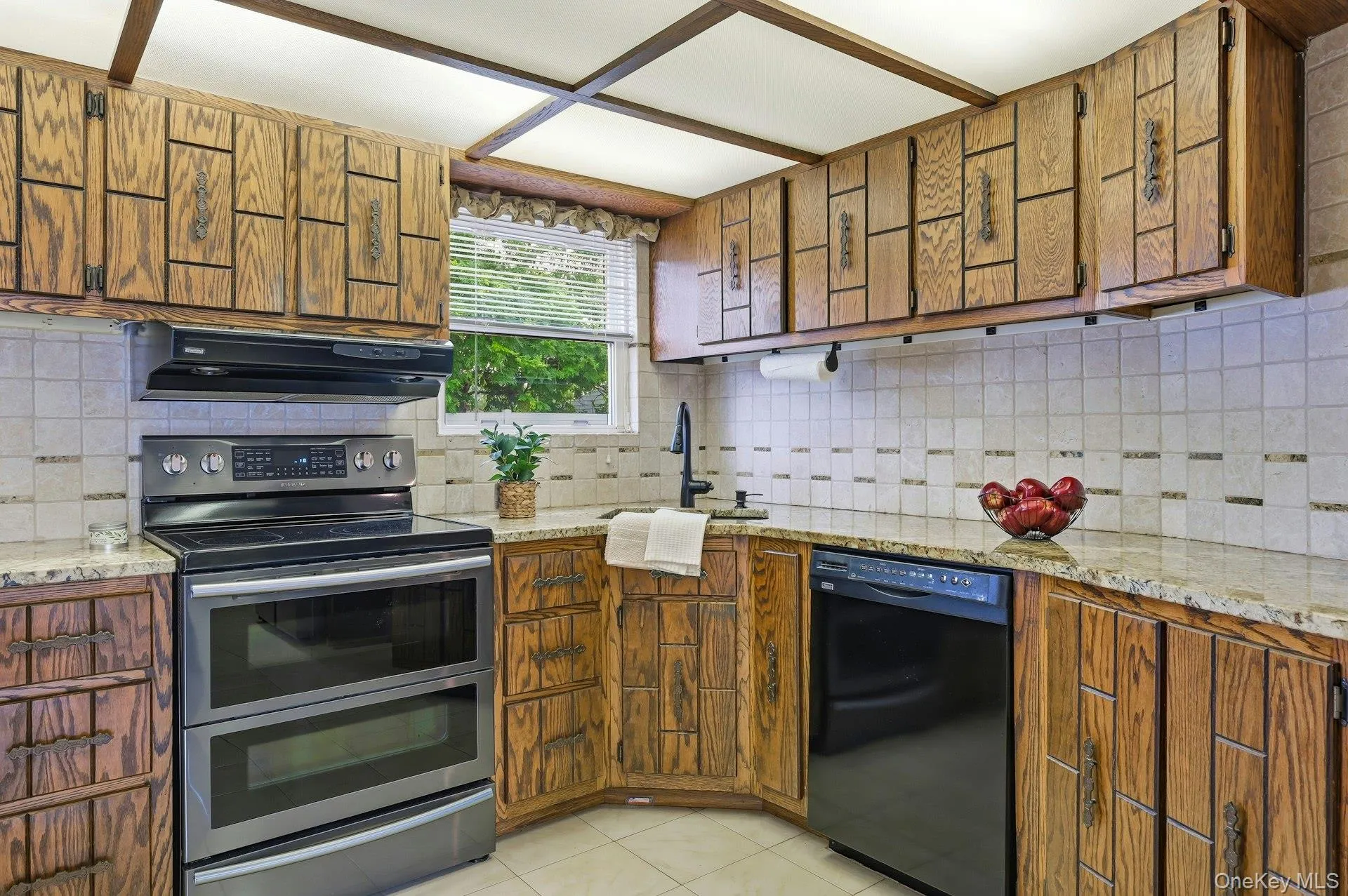 U-shaped kitchen with wood cabinetry and light-toned countertops U-shaped kitchen with wood cabinetry and light-toned countertops