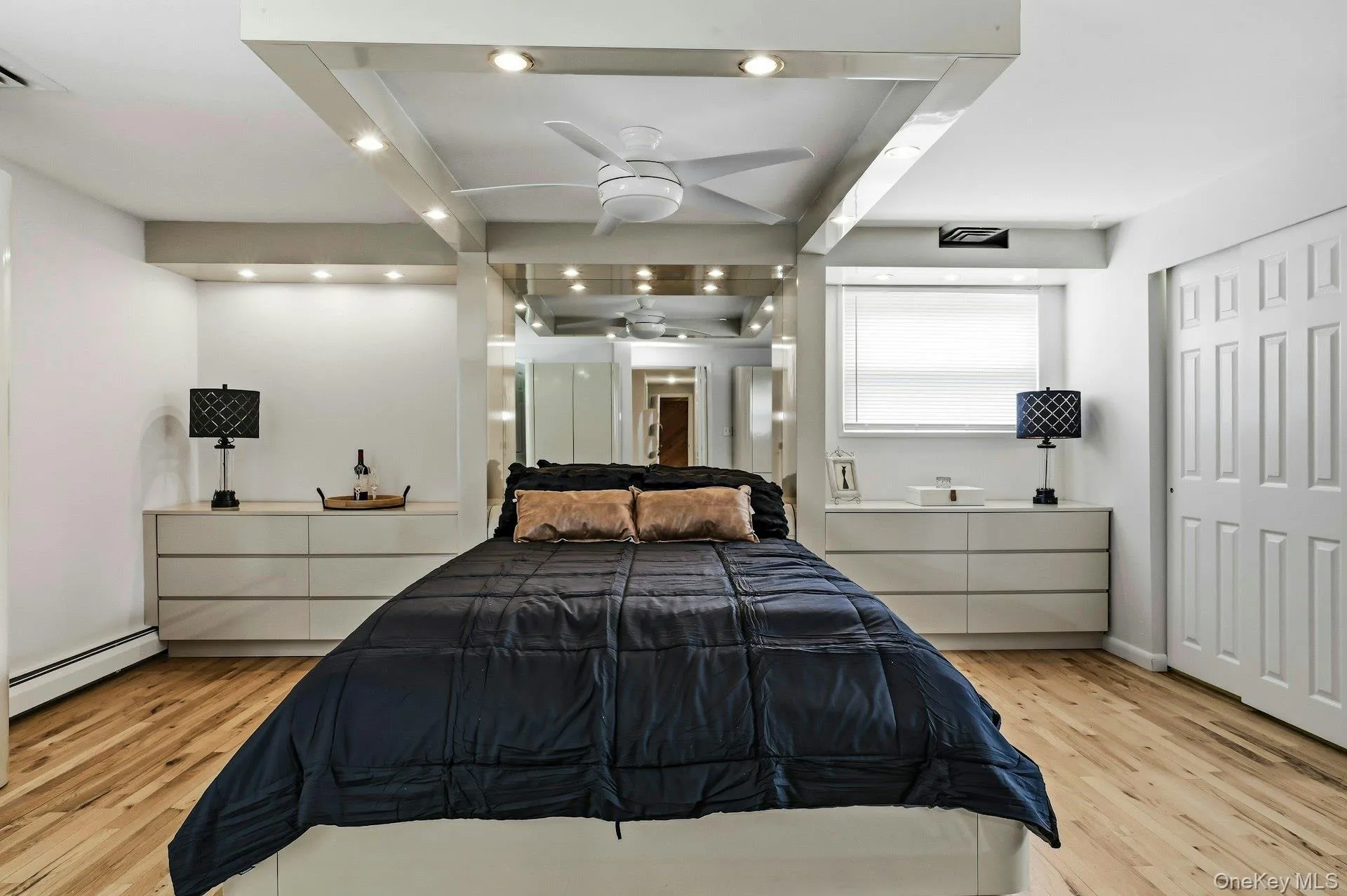 Recessed lighting accentuates the tray ceiling with a built-in ceiling fan Recessed lighting accentuates the tray ceiling with a built-in ceiling fan