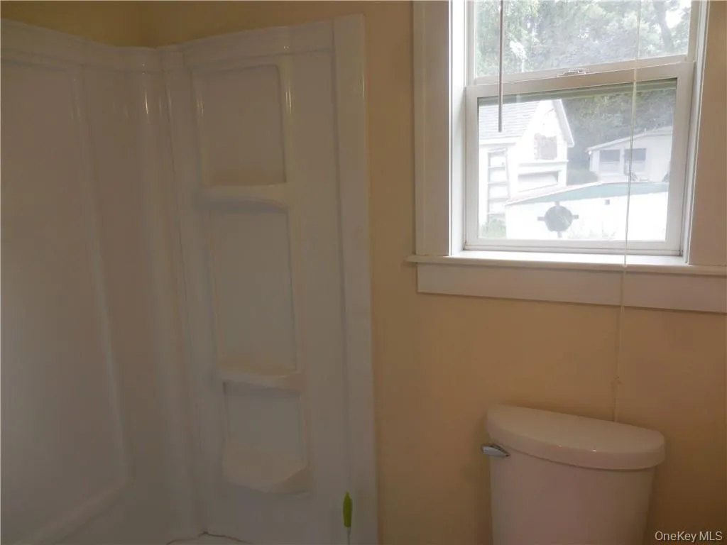 Bathroom featuring toilet and walk in shower Bathroom featuring toilet and walk in shower
