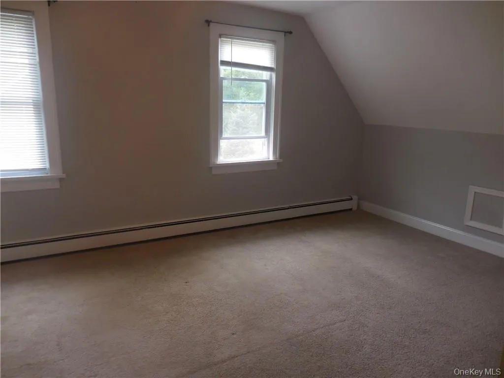 Bonus room with carpet flooring, baseboard heating, and lofted ceiling Bonus room with carpet flooring, baseboard heating, and lofted ceiling